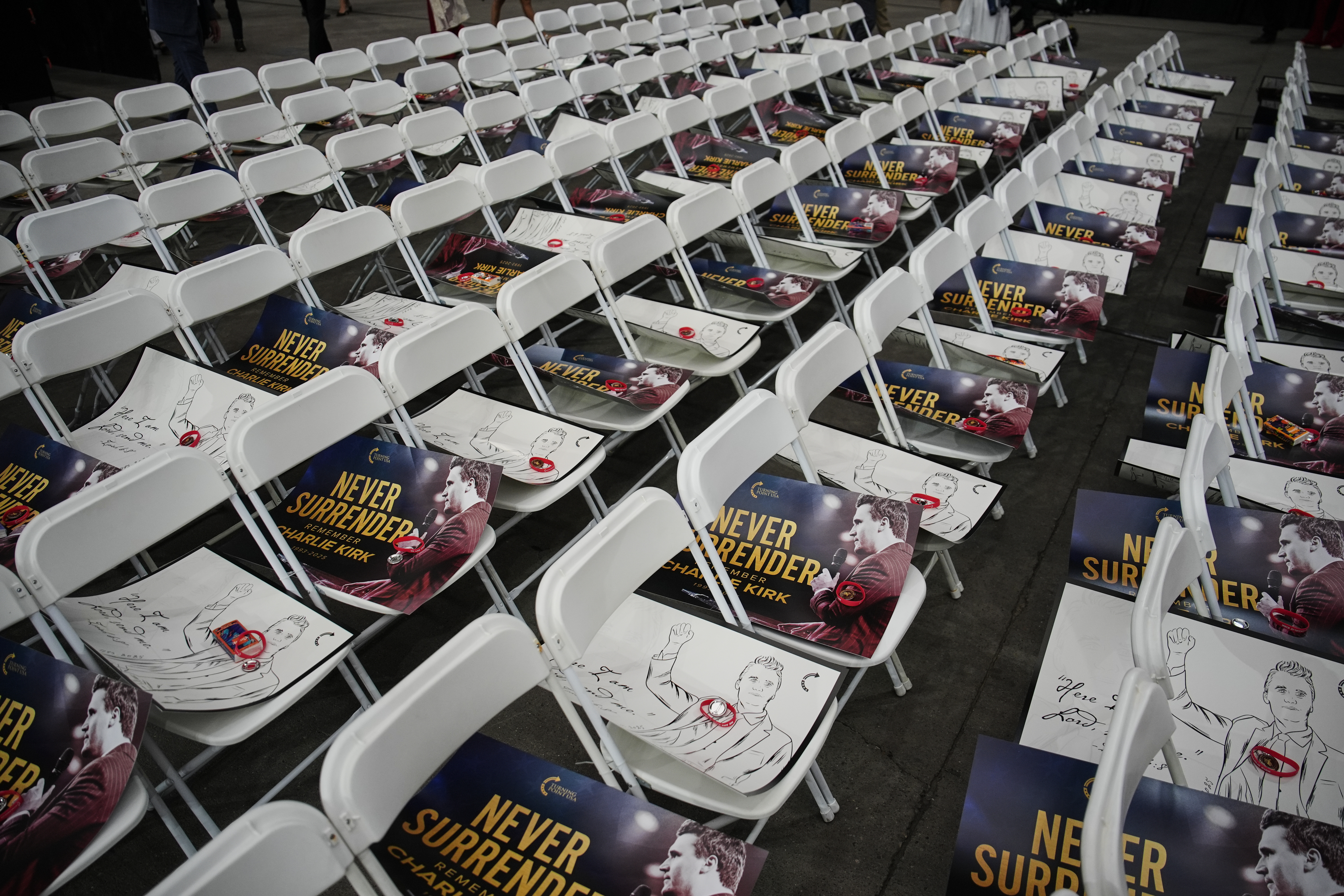 Posters of conservative activist Charlie Kirk are seen on chairs before his memorial Sunday, Sept. 21, 2025, at State Farm Stadium in Glendale, Ariz. (John Locher - AP)