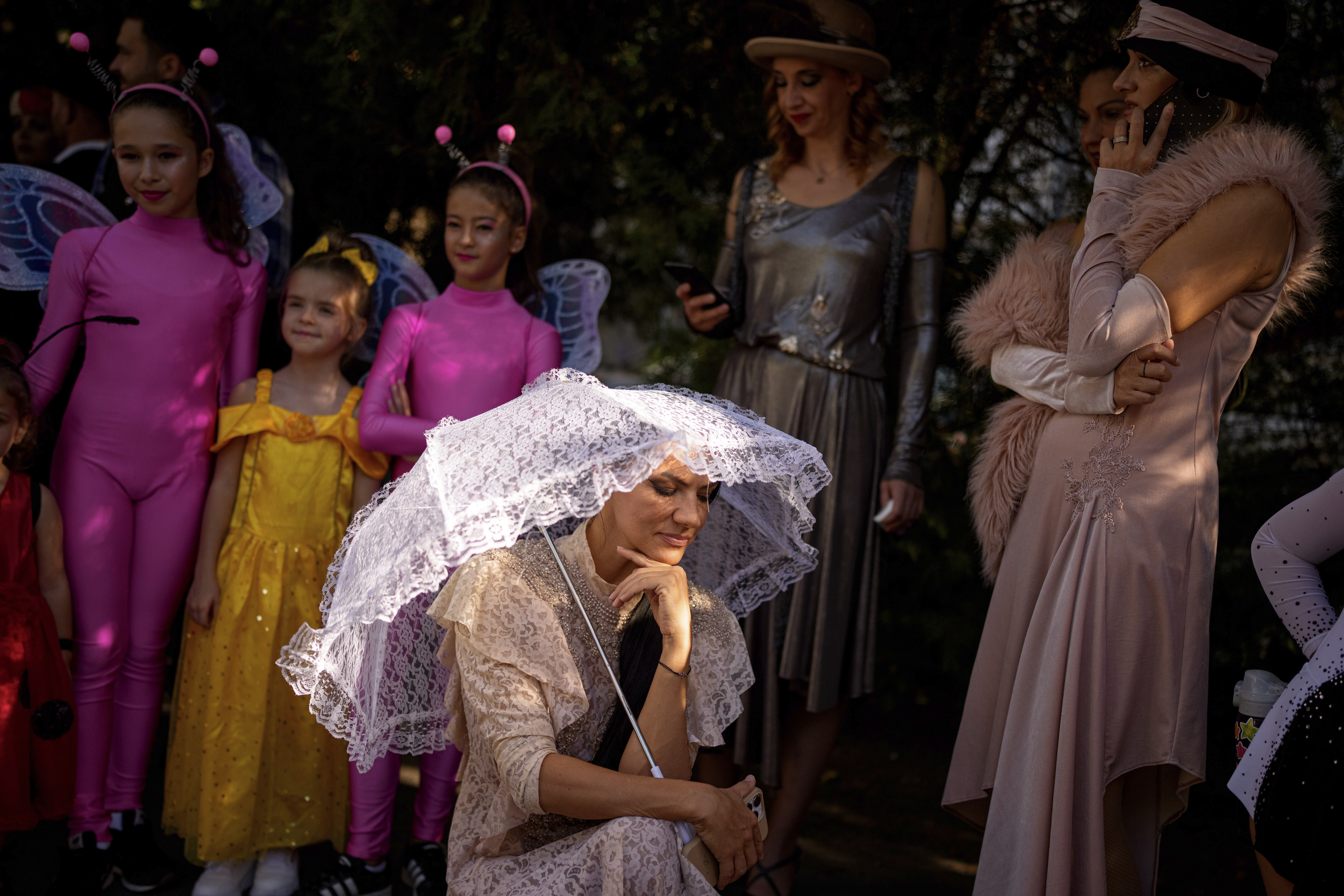 Entertainers wearing vintage styled outfits wait to take part in a parade marking the day when the Romanian capital was first mentioned in historical records, 566 years ago, in Bucharest, Romania, Saturday, Sept. 20, 2025. (Andreea Alexandru - AP)