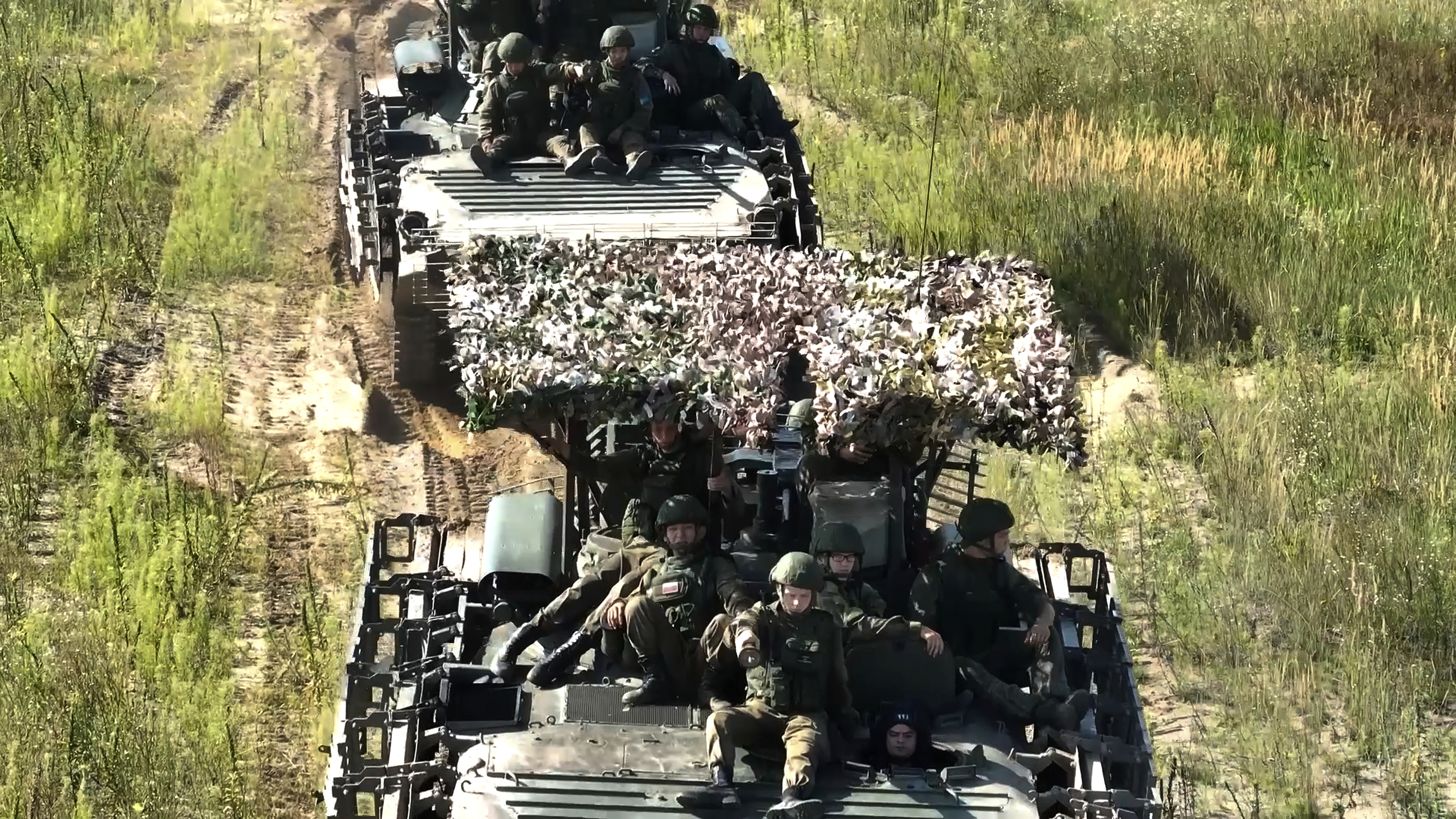 In this photo taken from video distributed by Russian Defense Ministry Press Service on Friday, Sept. 12, 2025, Armored vehicles drive during joint military drills held by Russia and Belarus. (Uncredited - Russian Defense Ministry Press Service)