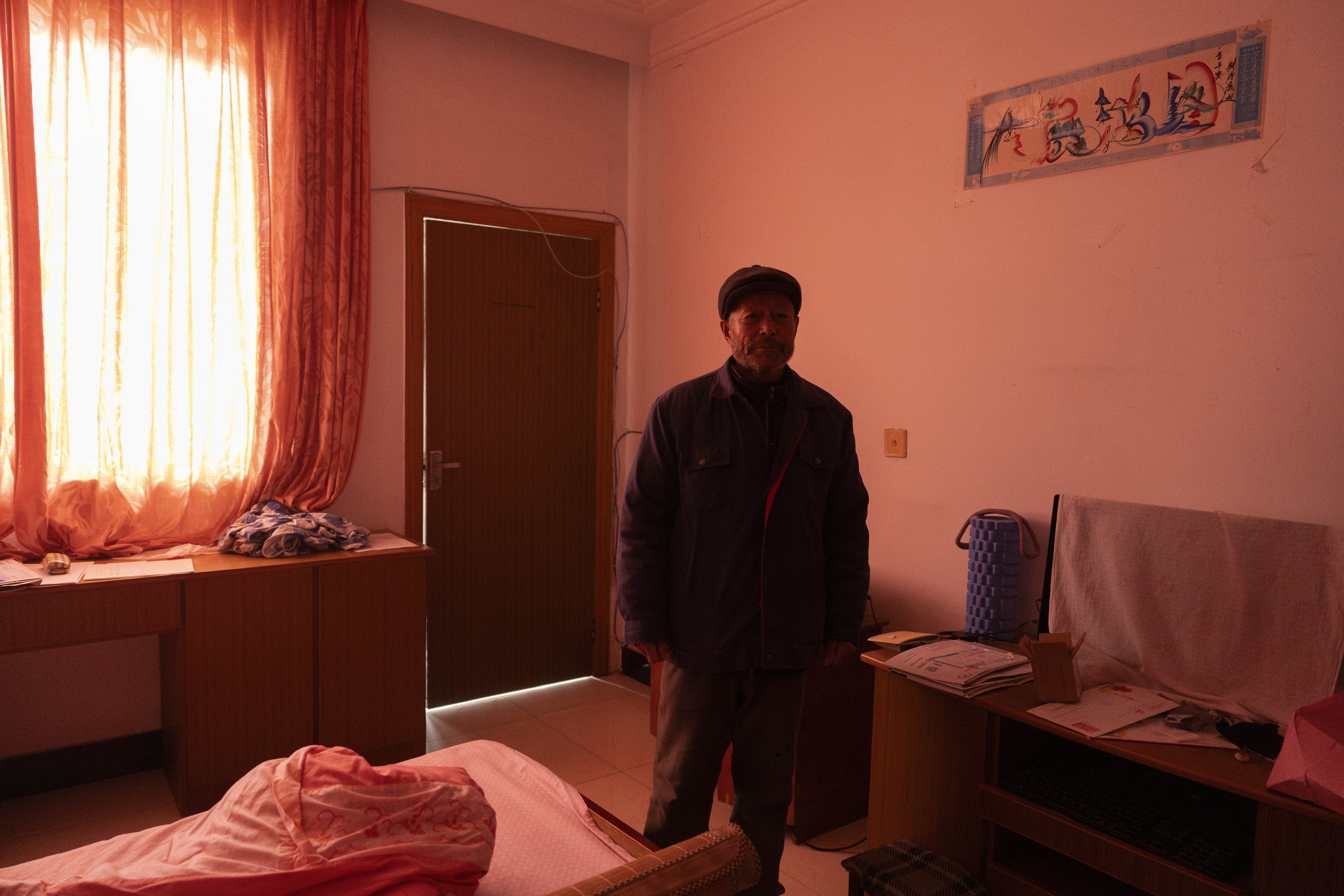 Petitioner Yang Guoliang stands in the room of his daughter, who has since been detained, which is covered with curtains for privacy from nearby police surveillance cameras in Changzhou in eastern China's Jiangsu Province on Friday, Dec. 13, 2024. (Ng Han Guan - AP)