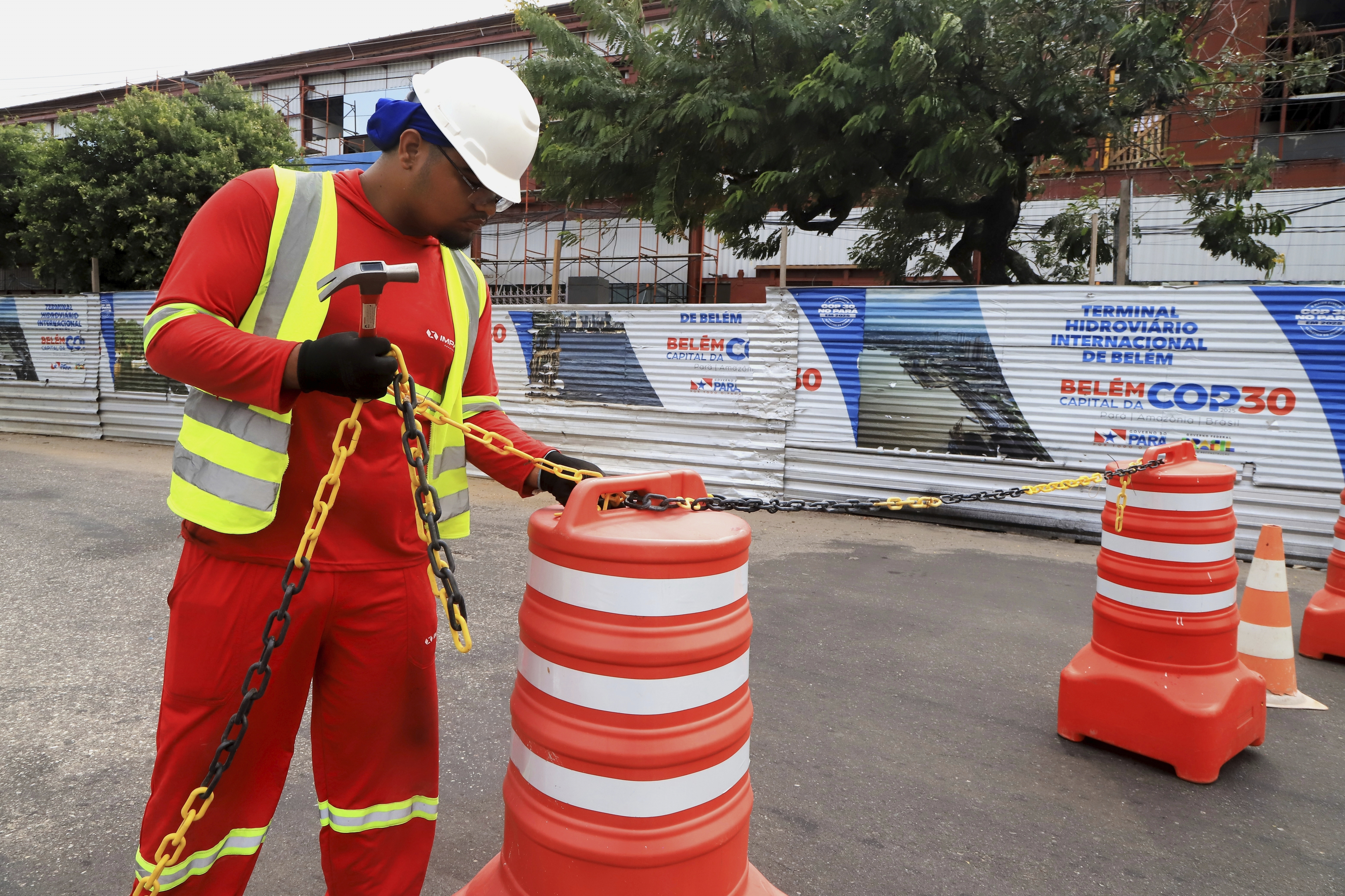A worker blocks the street to car traffic during construction for the upcoming COP30 U.N. Climate Summit in Belem, Brazil, Sept.18, 2025. (Paulo Santos - AP)