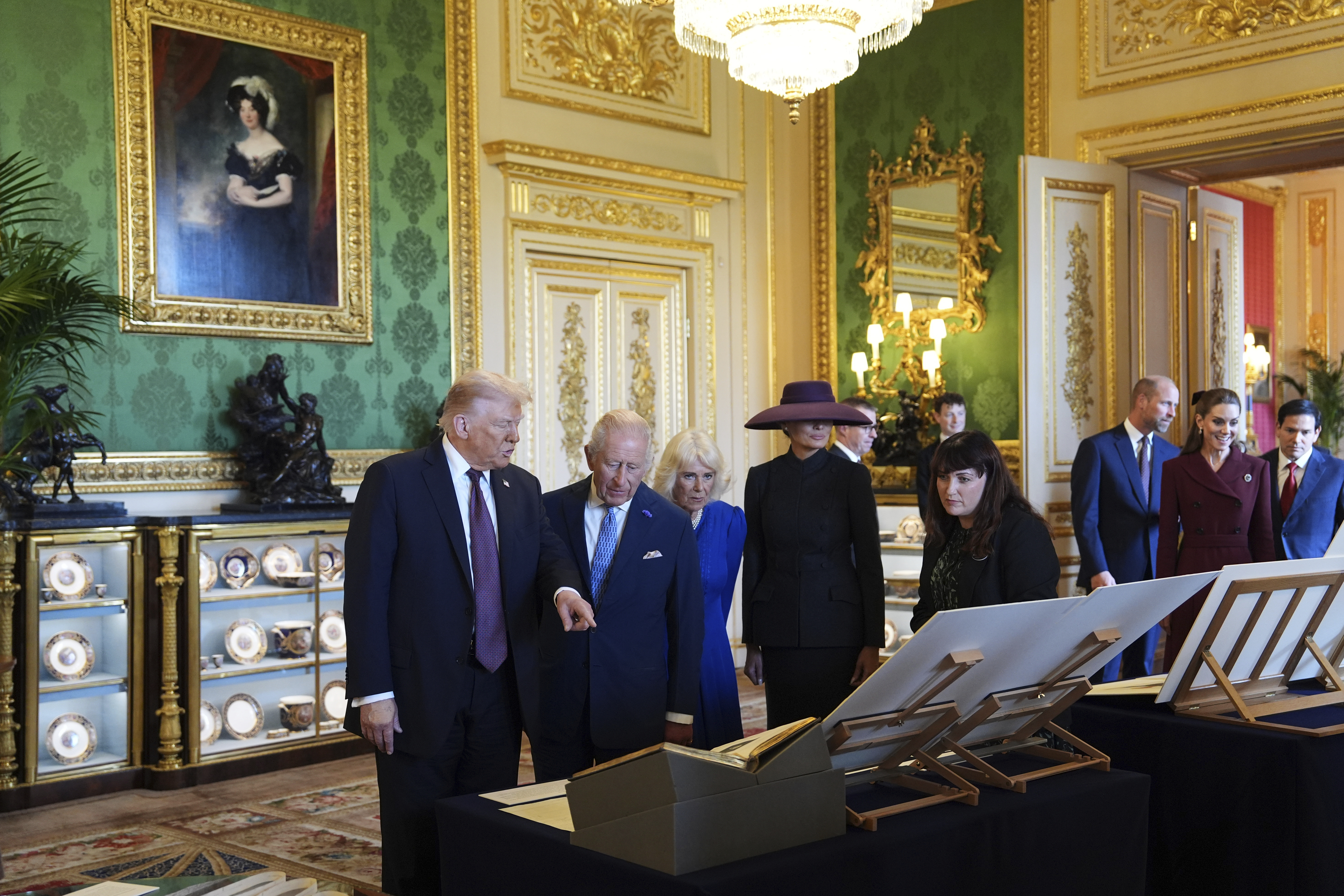 President Donald Trump, first lady Melania Trump, Britain's King Charles III and Britain's Queen Camilla view a special display of items from the Royal Collection relating to the United States of America, in the Green Drawing Room at Windsor Castle, in Windsor, England, Wednesday, Sept. 17, 2025. (Evan Vucci - AP)
