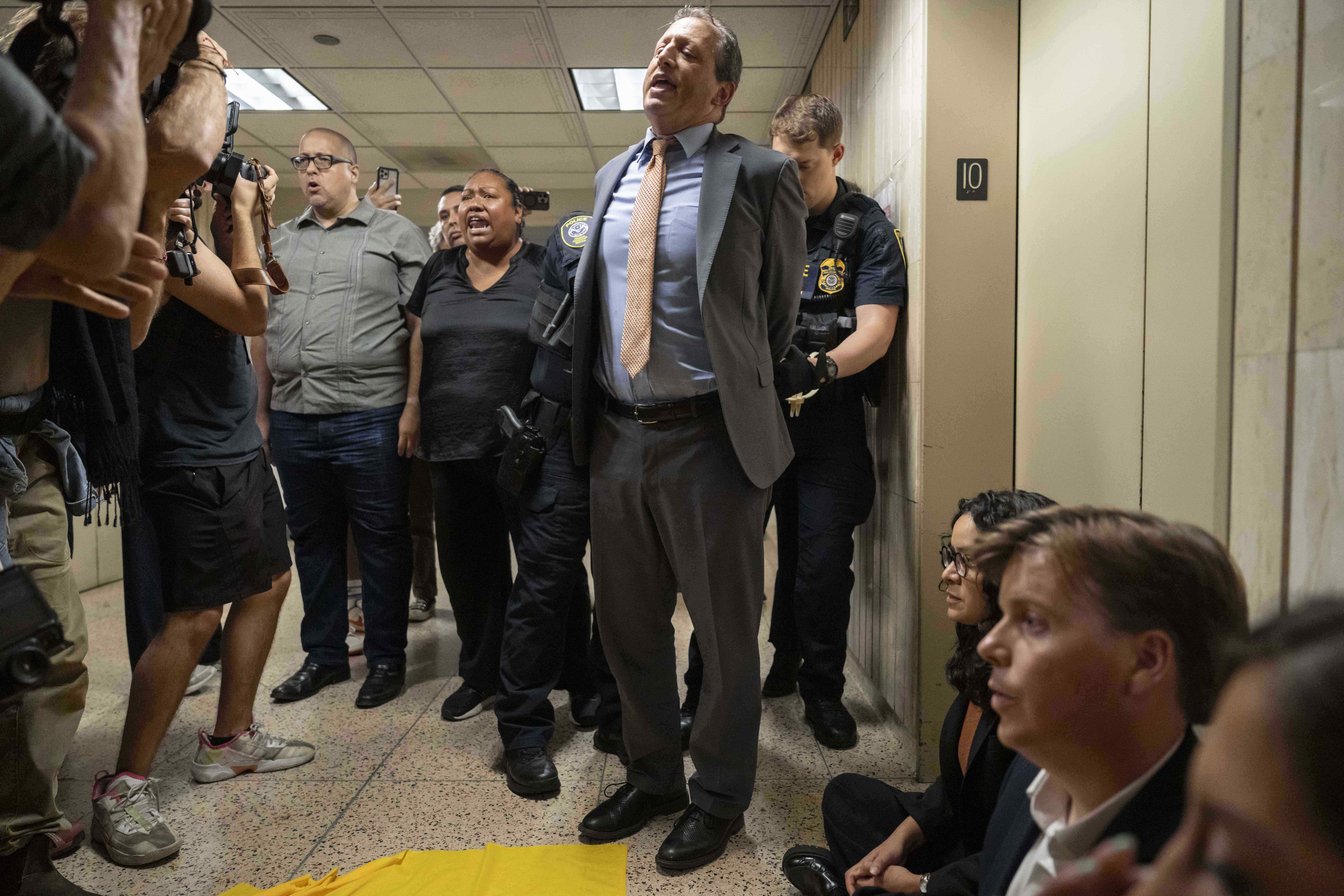 A federal agent detains New York City Comptroller Brad Lander and other elected officials after they demanded access to the inspect the detainment facility at immigration court at the Jacob K. Javits federal building, Thursday, Sept. 18, 2025, in New York. (Yuki Iwamura - AP)
