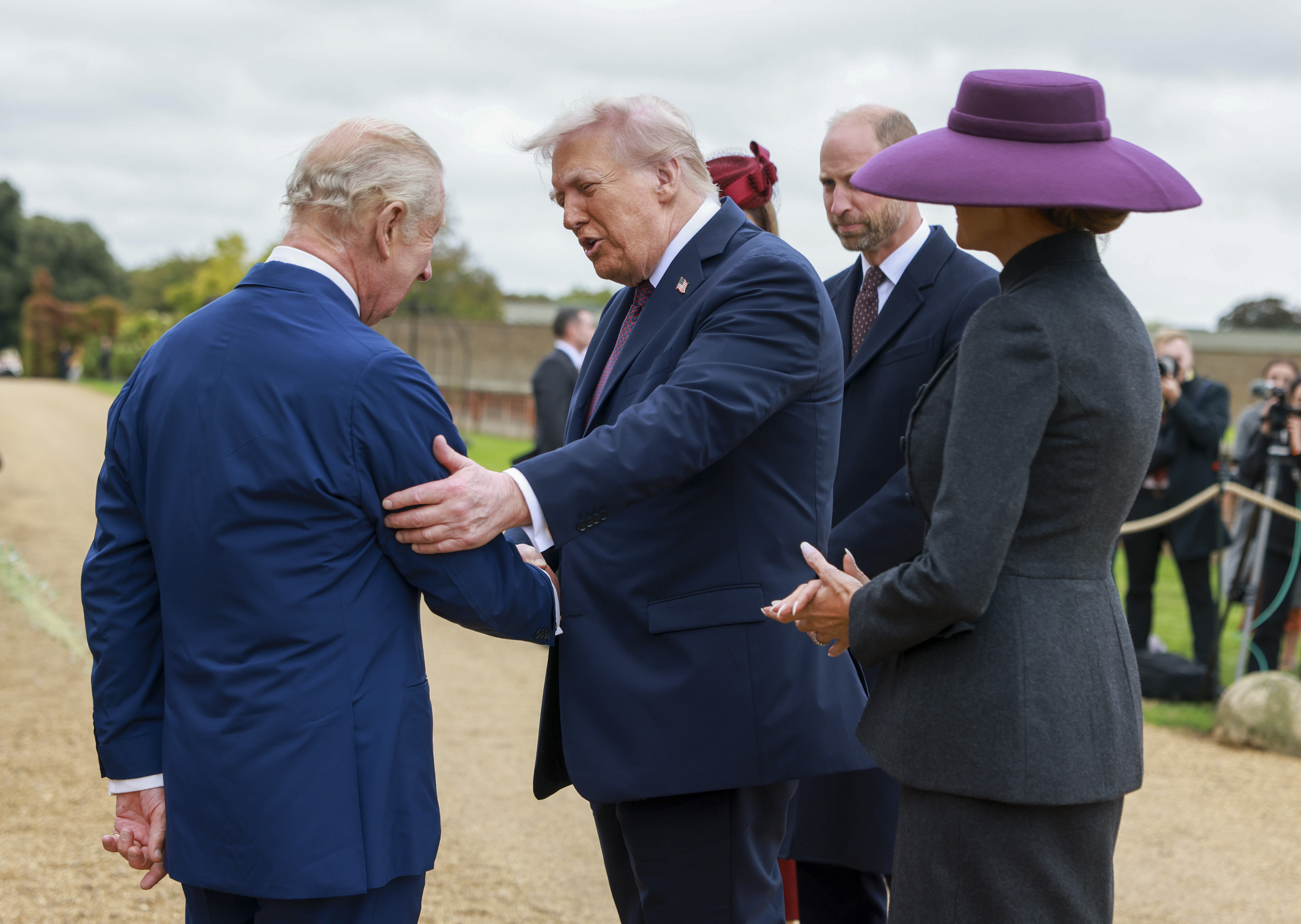 President Donald Trump and first lady Melania Trump are welcomed by Britain's King Charles III, in the Walled Garden on the Windsor Castle estate, in Windsor, England, Wednesday, Sept. 17, 2025. (Ian Vogler - Pool Daily Mirror)