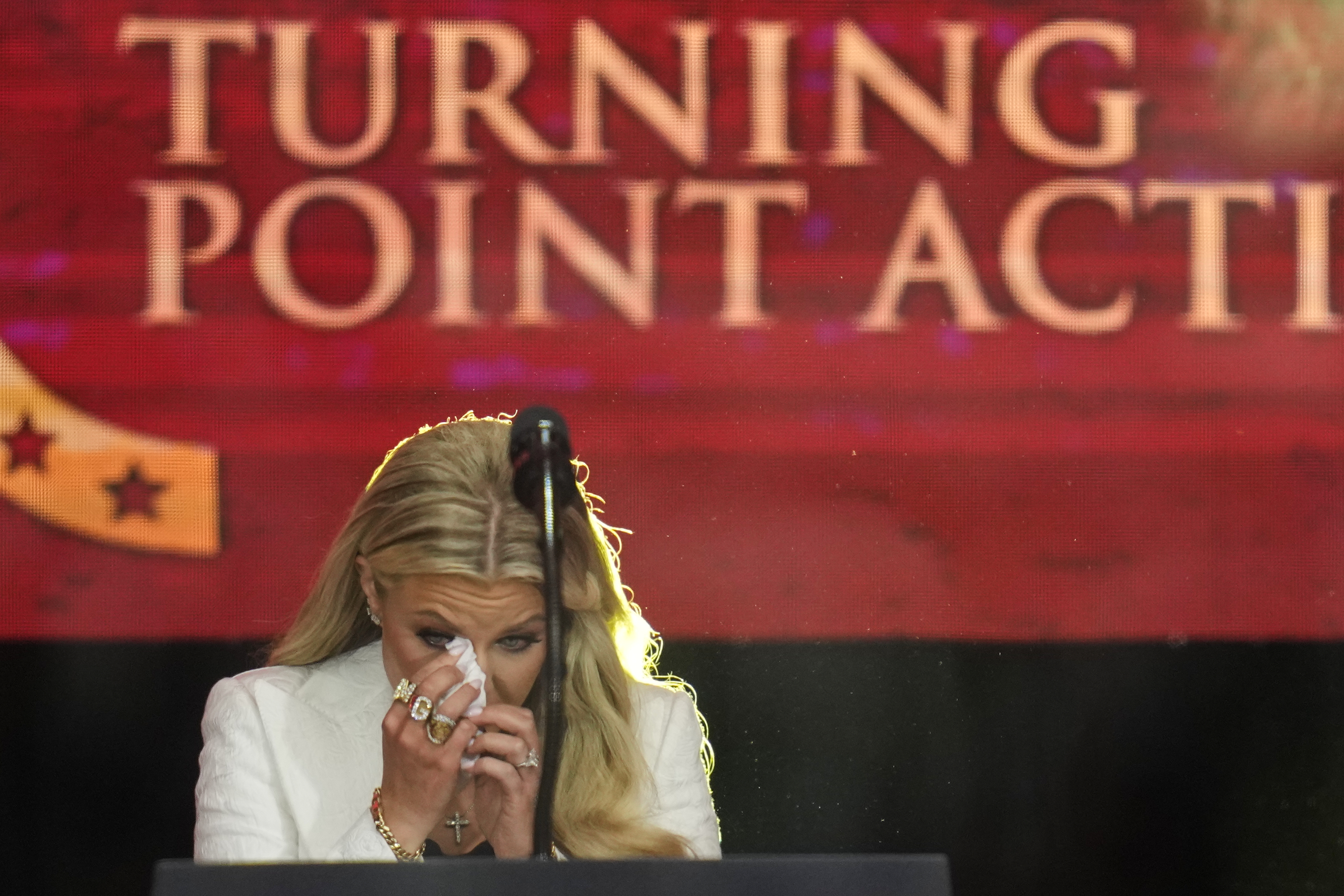 Erika Kirk wipes tears from her eyes before speaking at a memorial for her late husband conservative activist Charlie Kirk, Sunday, Sept. 21, 2025, at State Farm Stadium in Glendale, Ariz. (John Locher - AP)