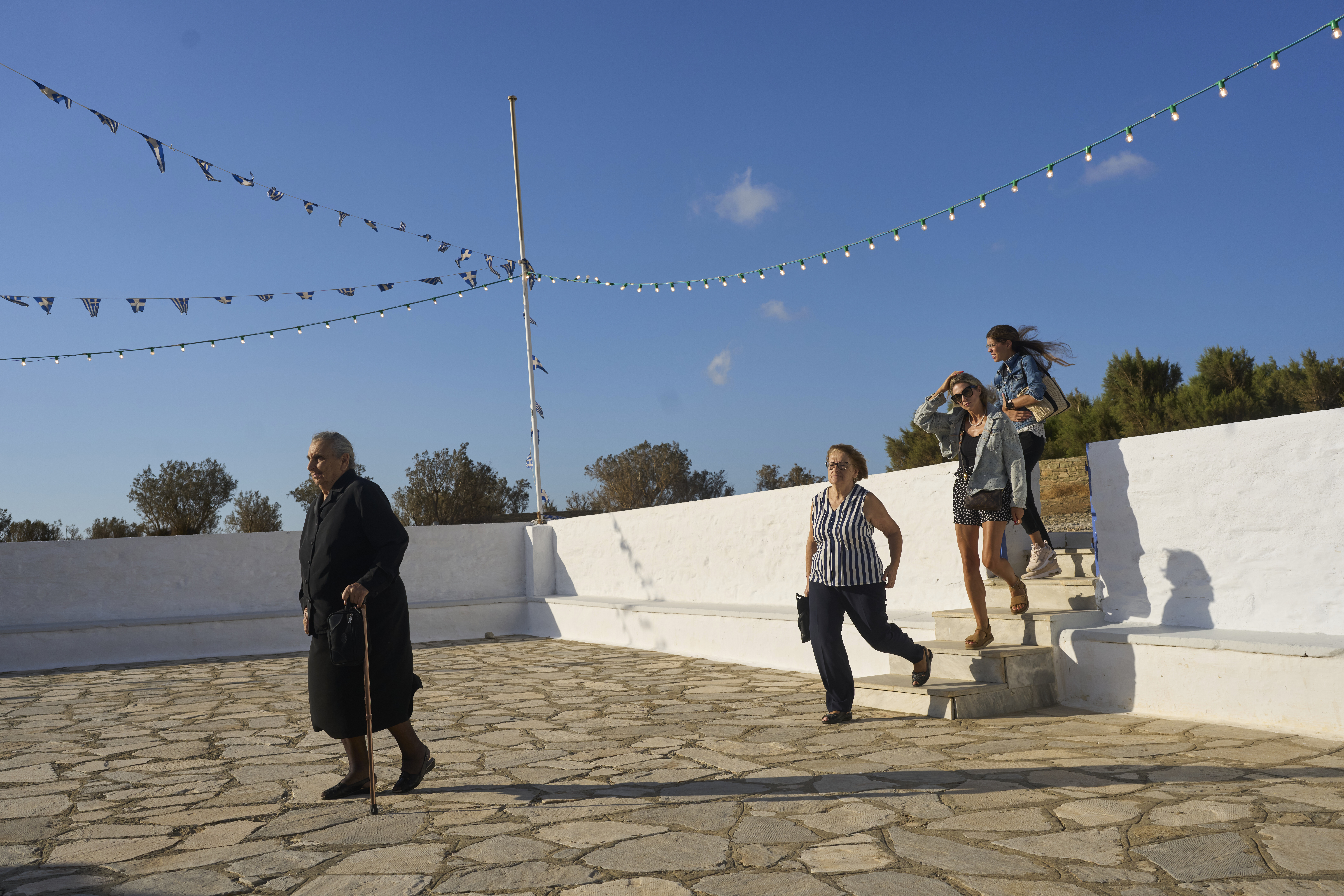 Worshippers arrive at the family-owned Agios Sostis chapel for for a liturgy service on the island of Tinos, Greece, Monday Sept. 8, 2025. (Petros Giannakouris - AP)