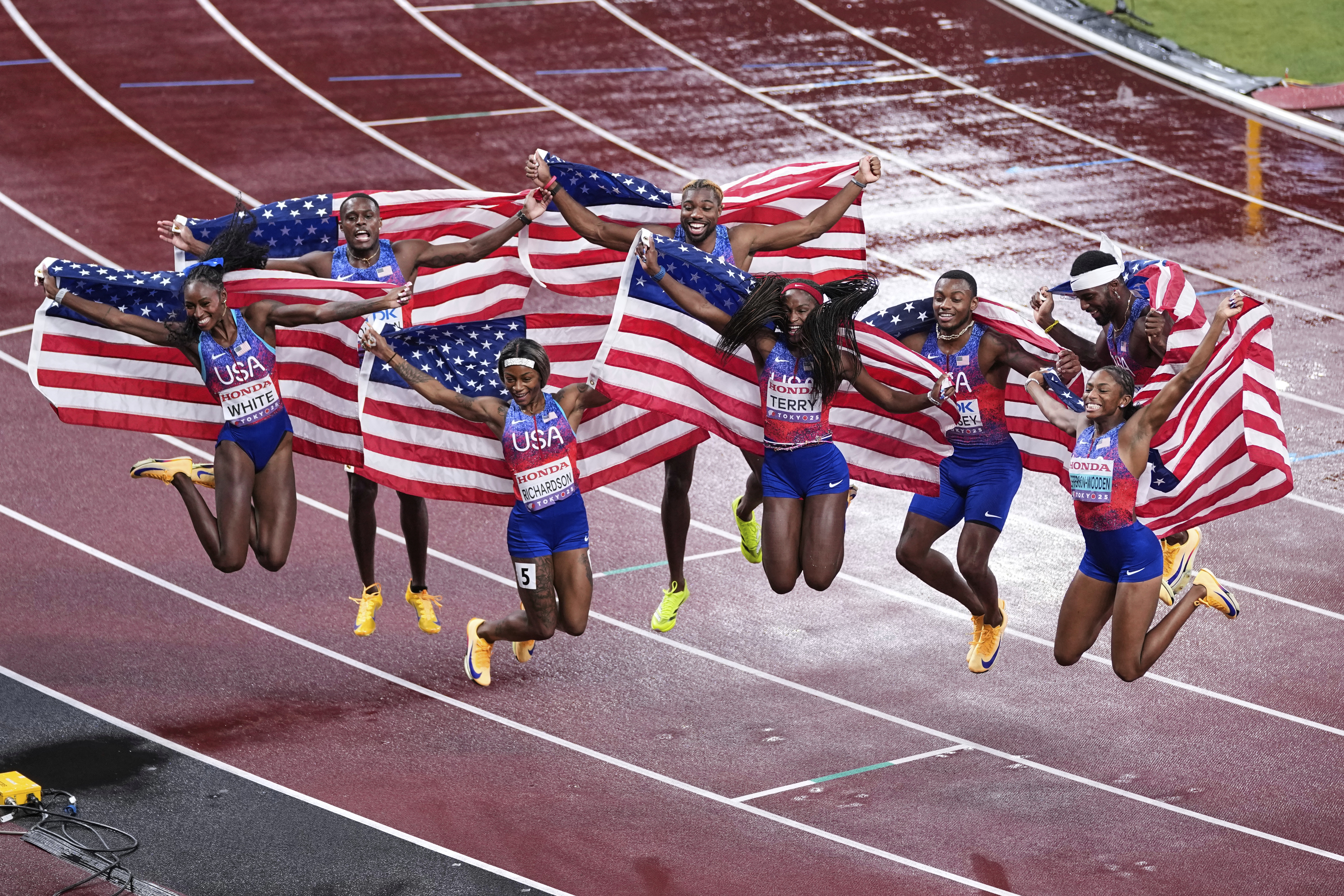United States' Kayla White, Sha'Carri Richardson, Twanisha Terry and Melissa Jefferson-Wooden of the women's 4 X 100 meters relay final and Christian Coleman, Noah Lyles, Courtney Lindsey and Kenneth Bednarek of the men's 4 X 100 meters relay final celebrate both of their gold medals at the World Athletics Championships in Tokyo, Sunday, Sept. 21, 2025. (Abbie Parr - AP)