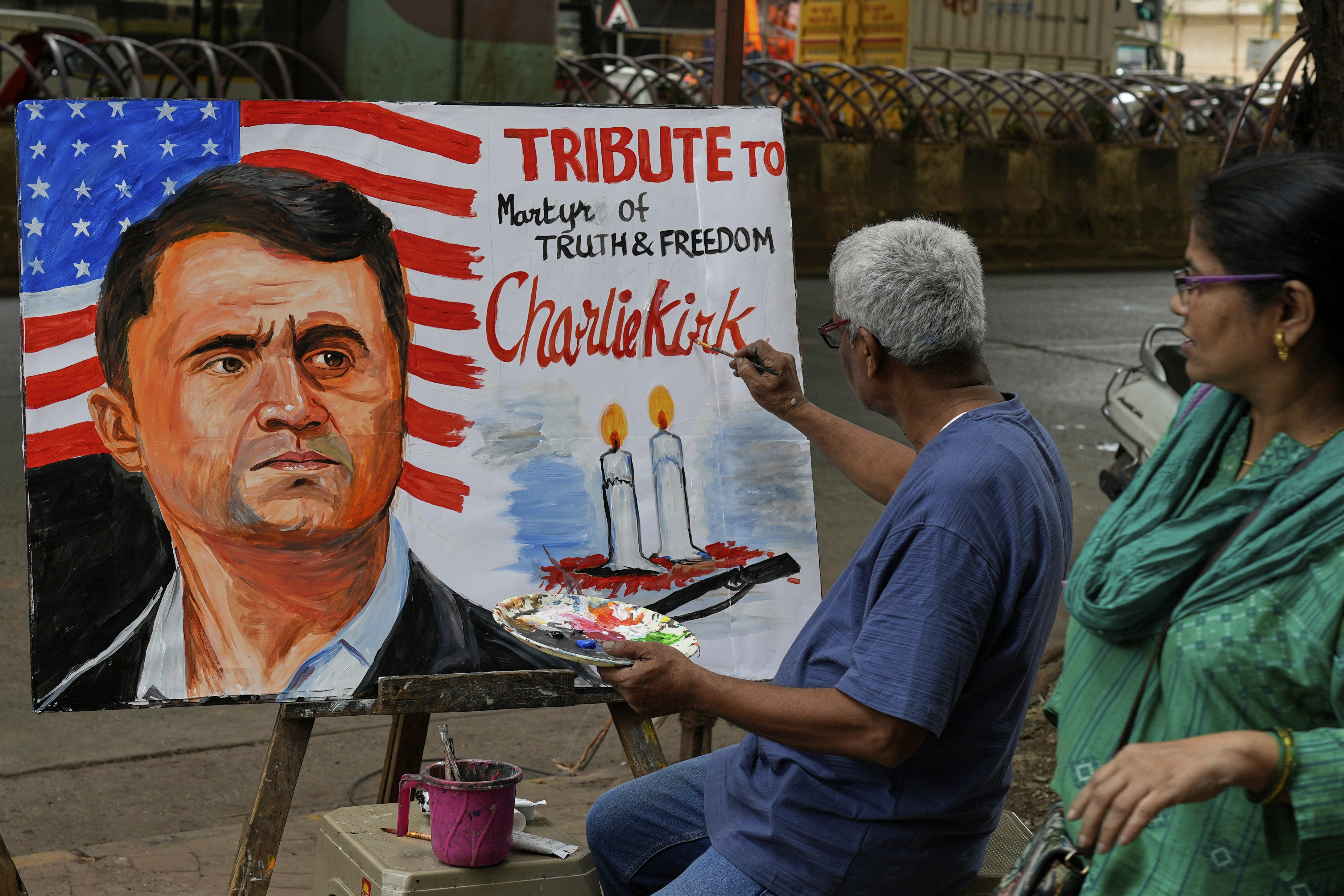 A teacher from Gurukul school of Art completes artwork to pay tribute to Charlie Kirk who was shot and killed, in Mumbai, India, Thursday, Sept. 11, 2025. (Rajanish Kakade - AP)