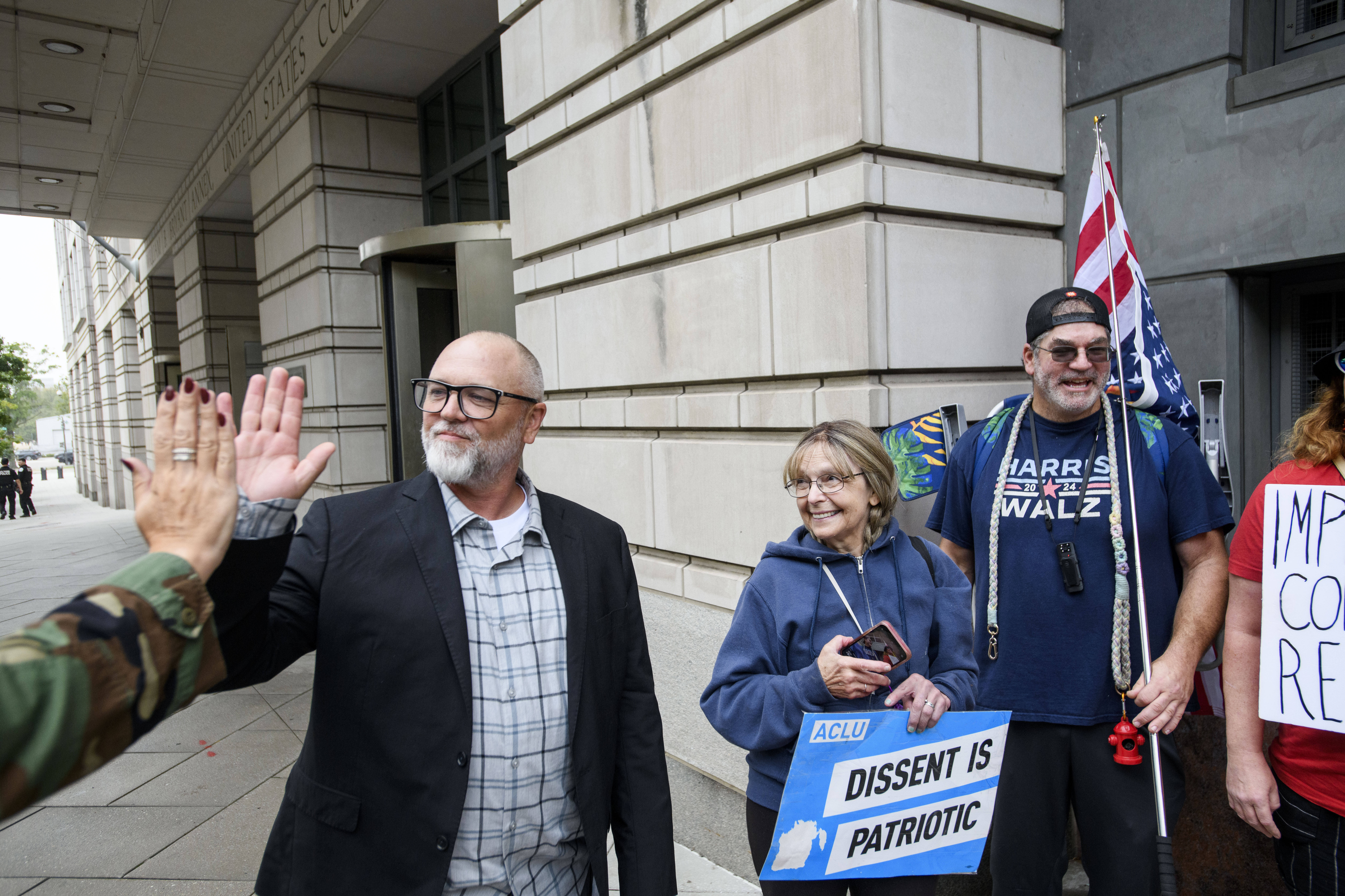 Jan Carey, left, a North Carolina veteran who burned a flag near the White House last month, talks with his supporters following his arraignment at the E. Barrett Prettyman Federal Courthouse, Wednesday, Sept. 17, 2025, in Washington. (Rod Lamkey - FR172078)