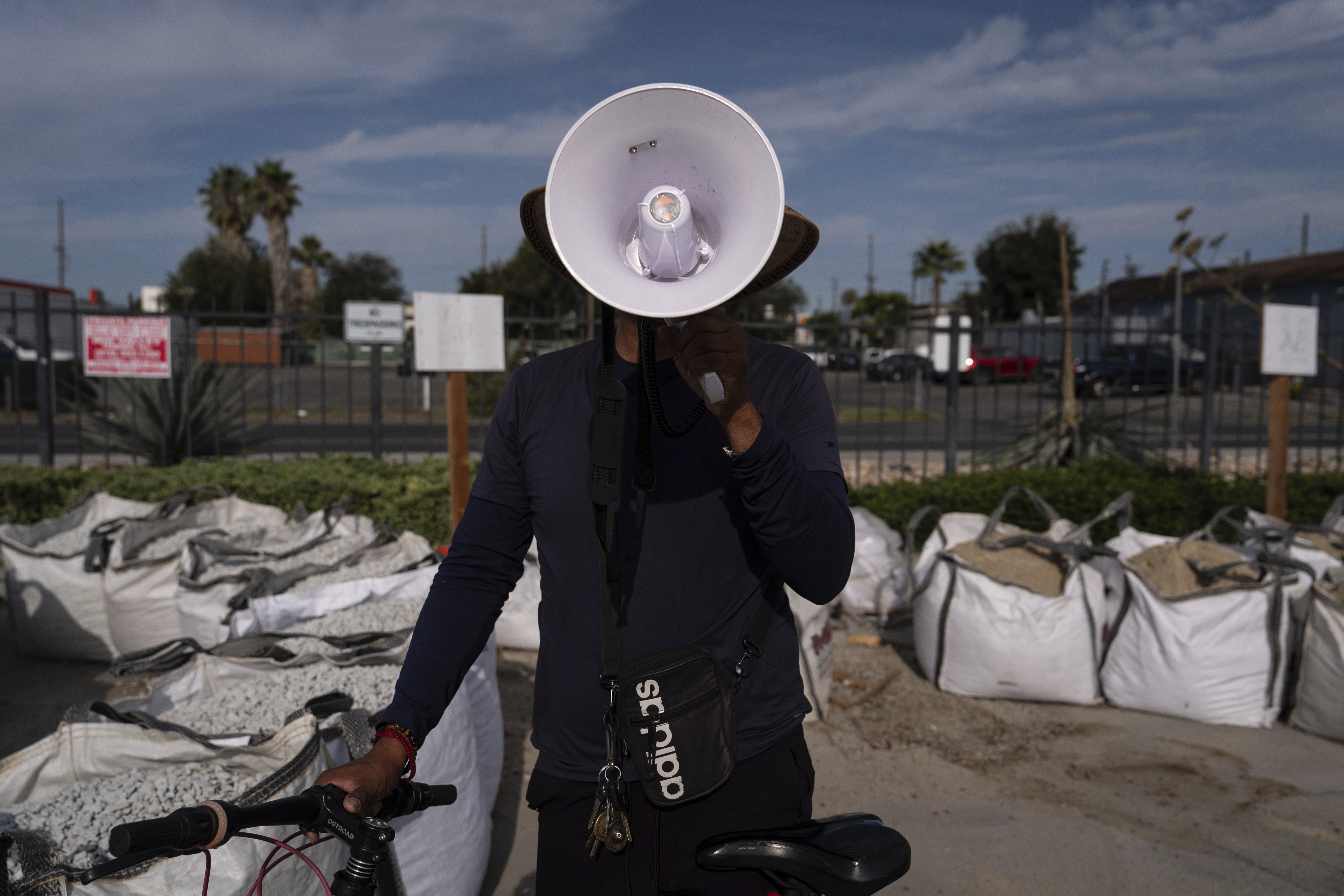 Luis poses with a megaphone used to alert other day laborers of ICE operations in the parking lot of a Home Depot in the Van Nuys section of Los Angeles, Aug. 28, 2025. (Jae C. Hong - AP)