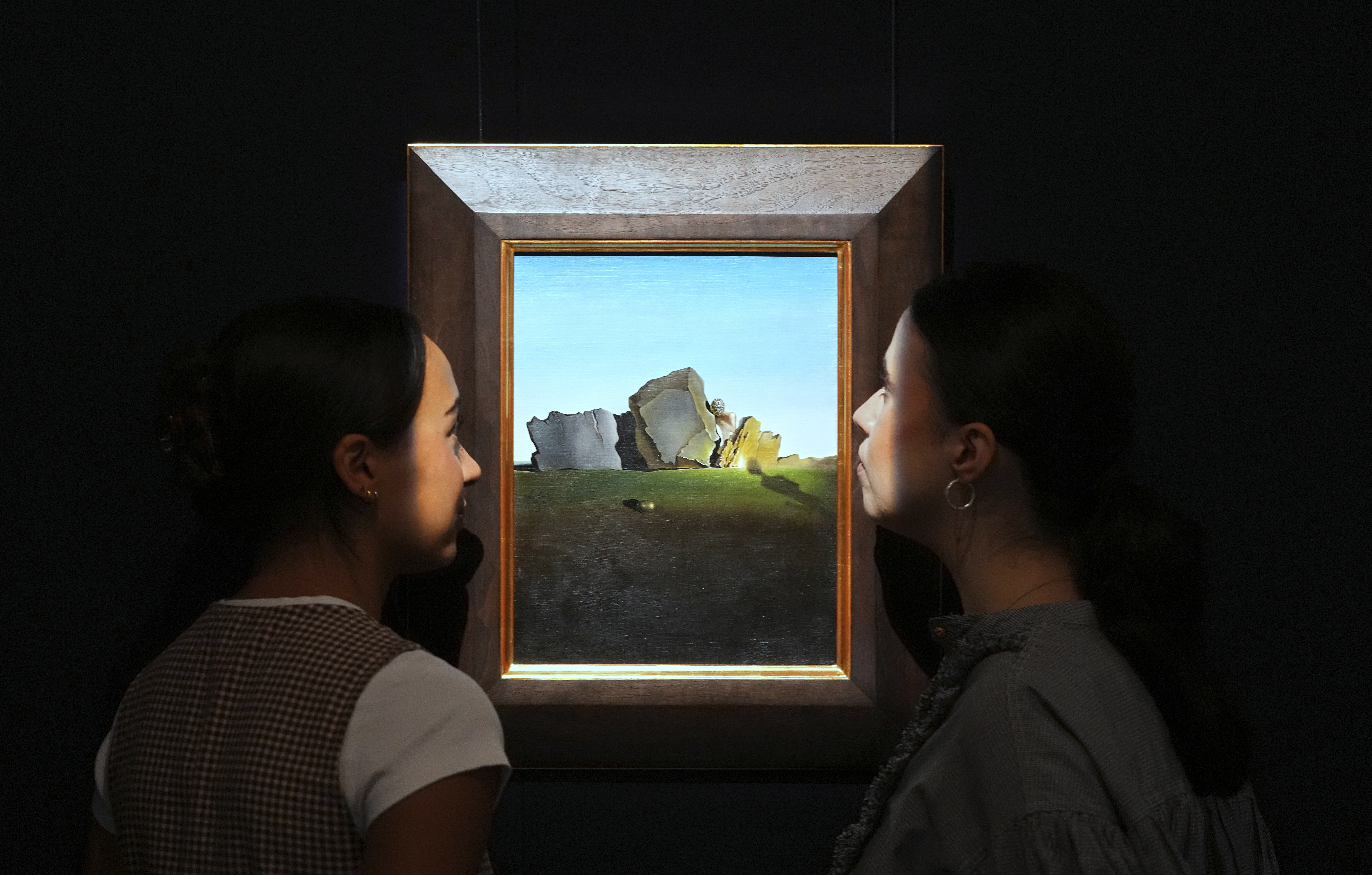 A painting by Salvador Dali called Symbiose de la tete aux coquillages is displayed at Sotheby's auction rooms, the painting estimated at 2-3 million US dollars is part of a collection of surrealist masterpieces unveiled in London ahead of their sale in New York, Friday, Sept. 19, 2025. (Kirsty Wigglesworth - AP)