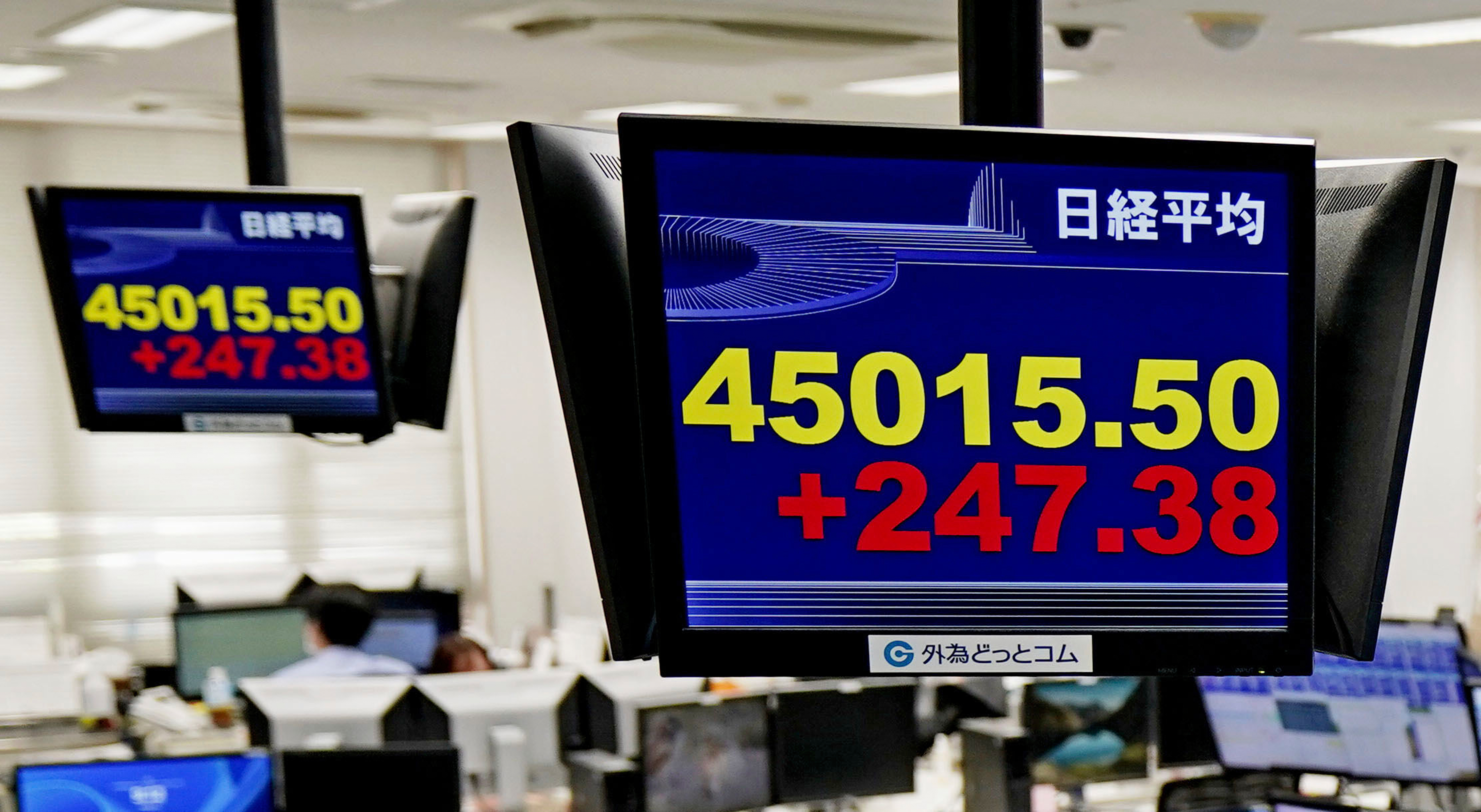 Employees of a foreign exchange dealing company sit under an electronic board showing the stock index of Japan's Nikkei 225, in Tokyo Tuesday, Sept. 16, 2025, in Tokyo. (Uncredited - Kyodo News)
