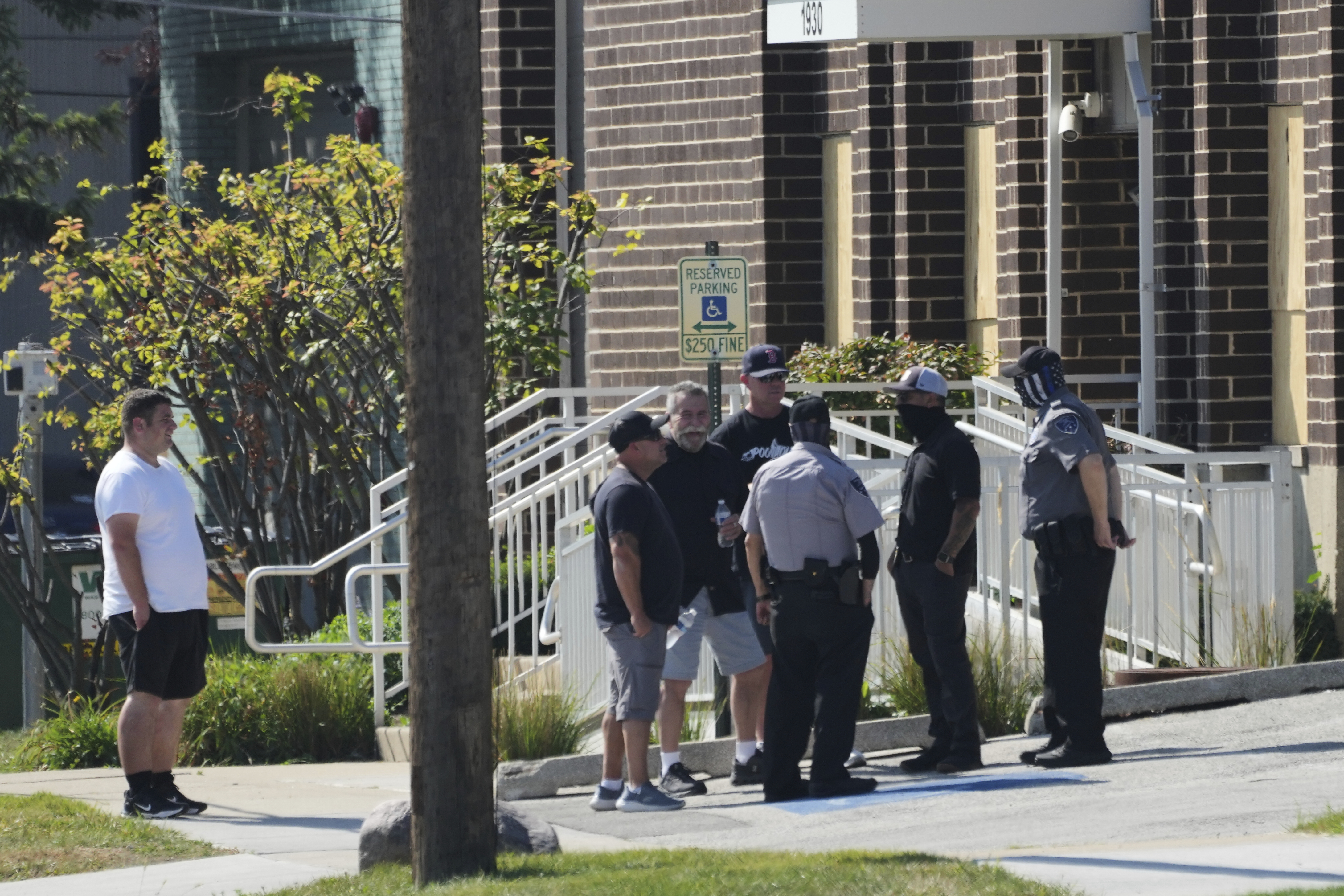 People talk with federal agents and security guards outside of an ICE (U.S. Immigration and Customs Enforcement) processing facility in the Chicago suburb of Broadview, Ill., Wednesday, Sept. 17, 2025. (Nam Y. Huh - AP)