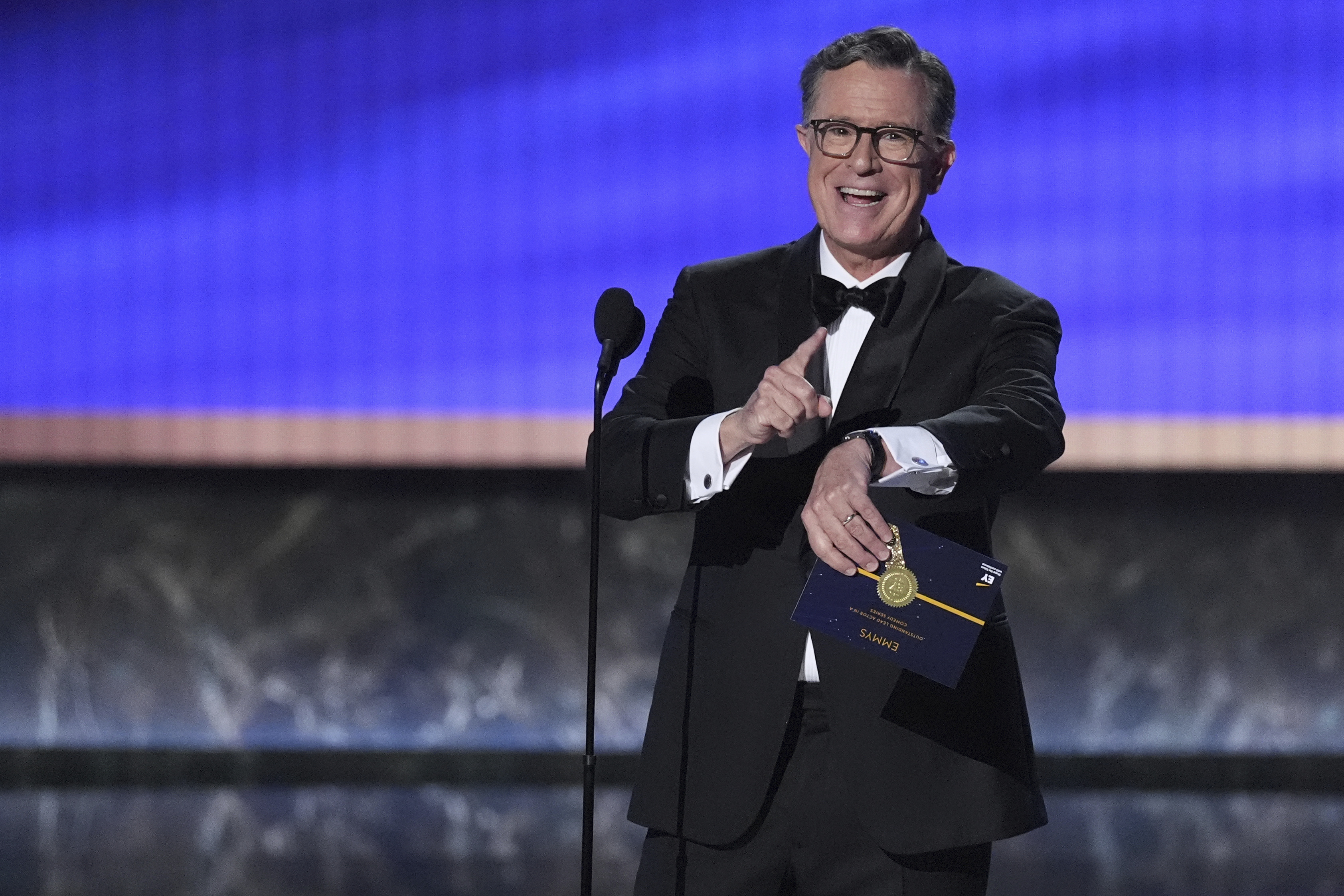 Stephen Colbert presents the award for outstanding lead actor in a comedy series during the 77th Primetime Emmy Awards on Sunday, Sept. 14, 2025, at the Peacock Theater in Los Angeles. (Chris Pizzello - Invision)