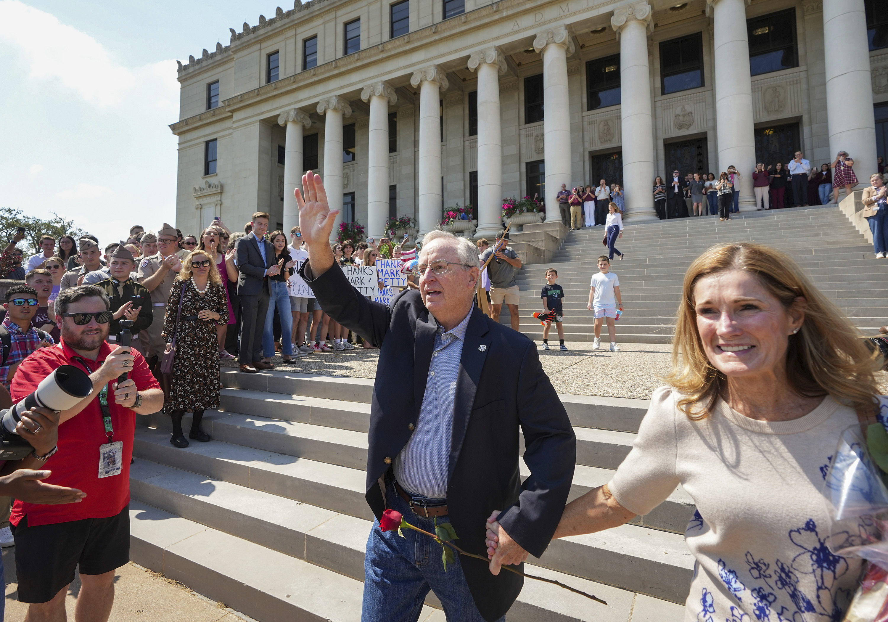 Texas A&M University President Mark Welsh, accompanied by his wife, Betty, exits the administration building after resigning in College Station, Texas, on Friday, Sept. 19, 2025. (Jay Janner - Austin American-Statesman)