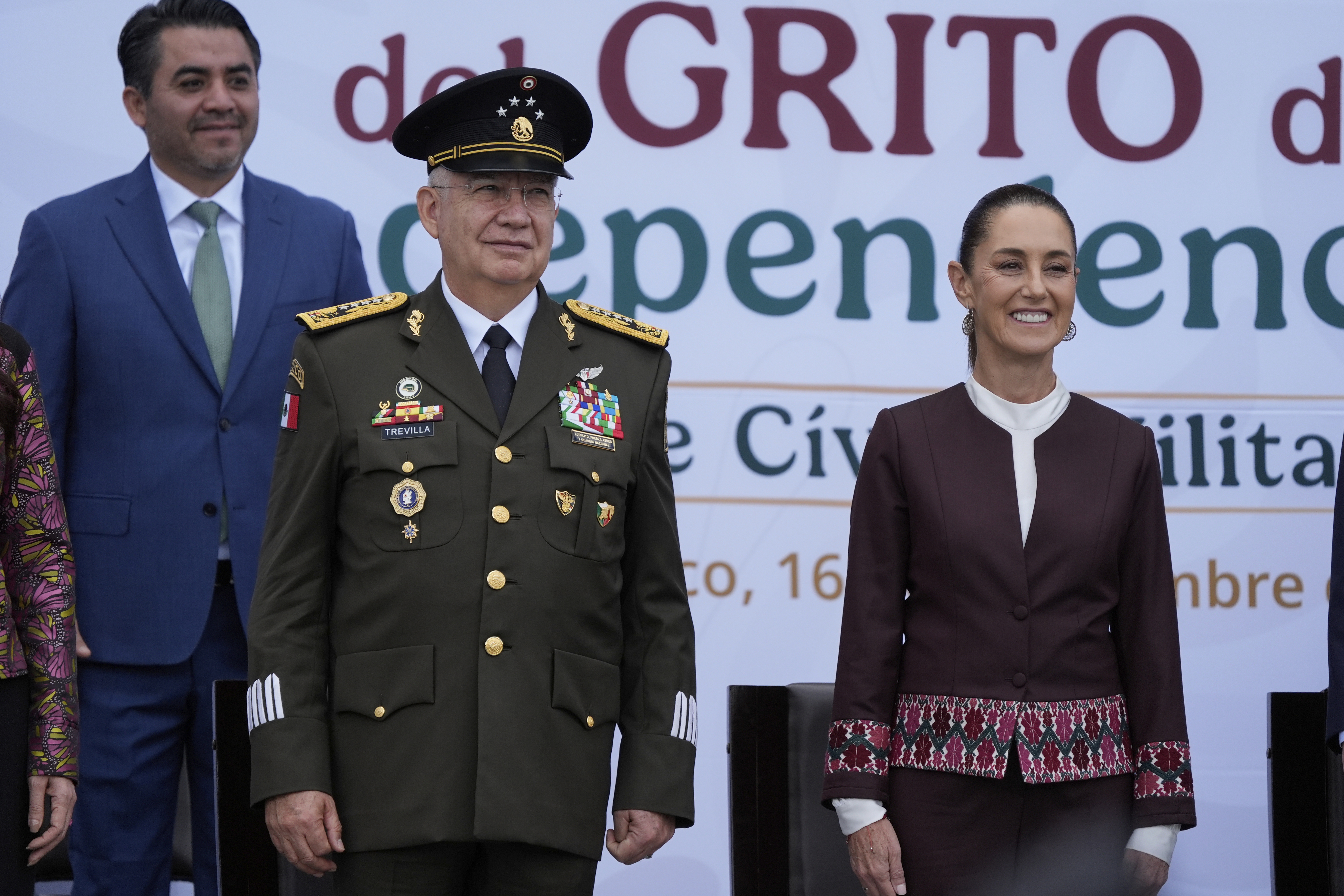 Defense Minister Gen. Ricardo Trevilla Trejo, left, and President Claudia Sheinbaum look out at troops before the start of the annual Independence Day parade in the capital's main square, the Zocalo, in Mexico City, Tuesday, Sept. 16, 2025. (Fernando Llano - AP)