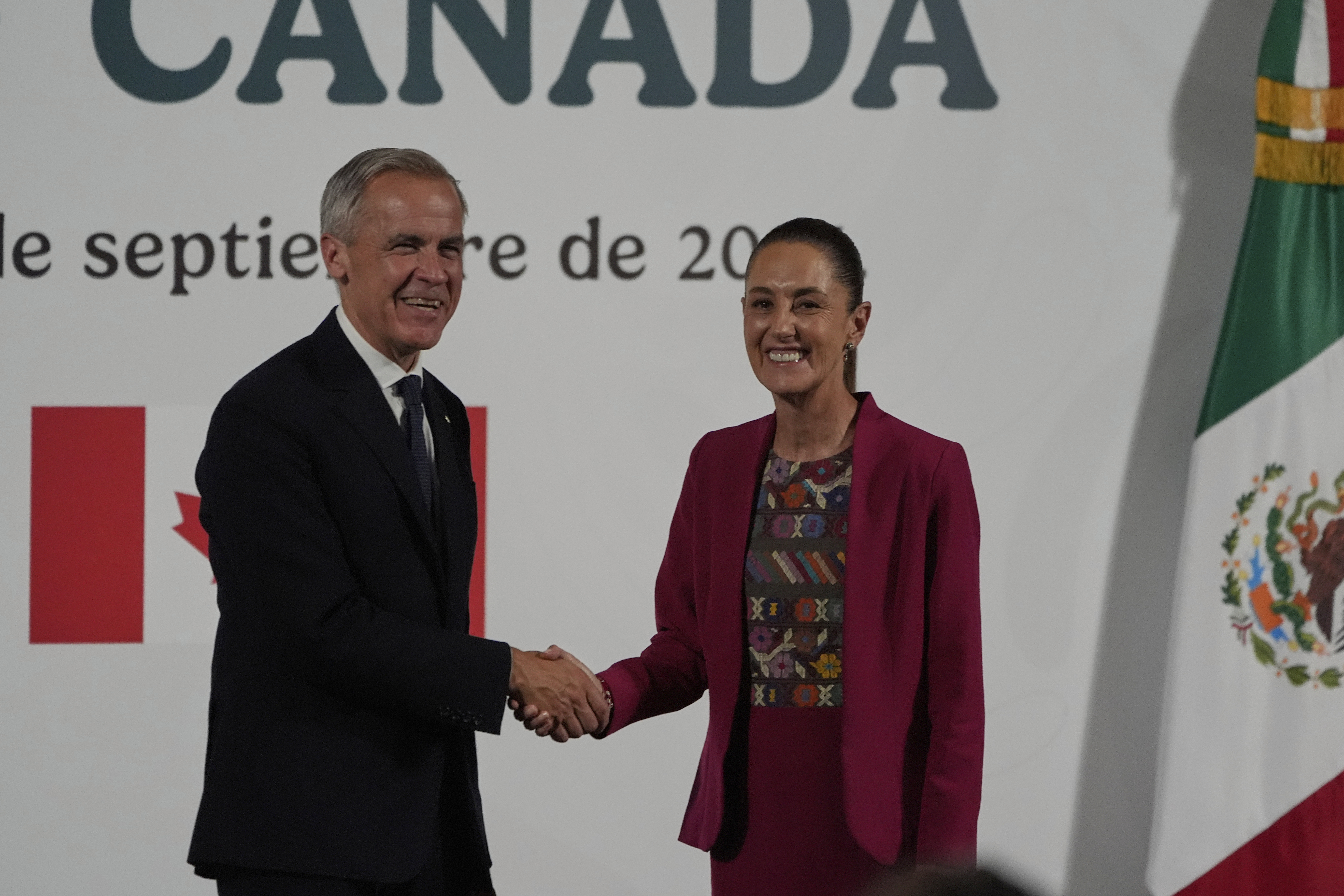 Canada's Prime Minister Mark Carney, left, and Mexico's President Claudia Sheinbaum shake hands after a joint press conference at the National Palace in Mexico City, Thursday, Sept. 18, 2025. (Fernando Llano - AP)