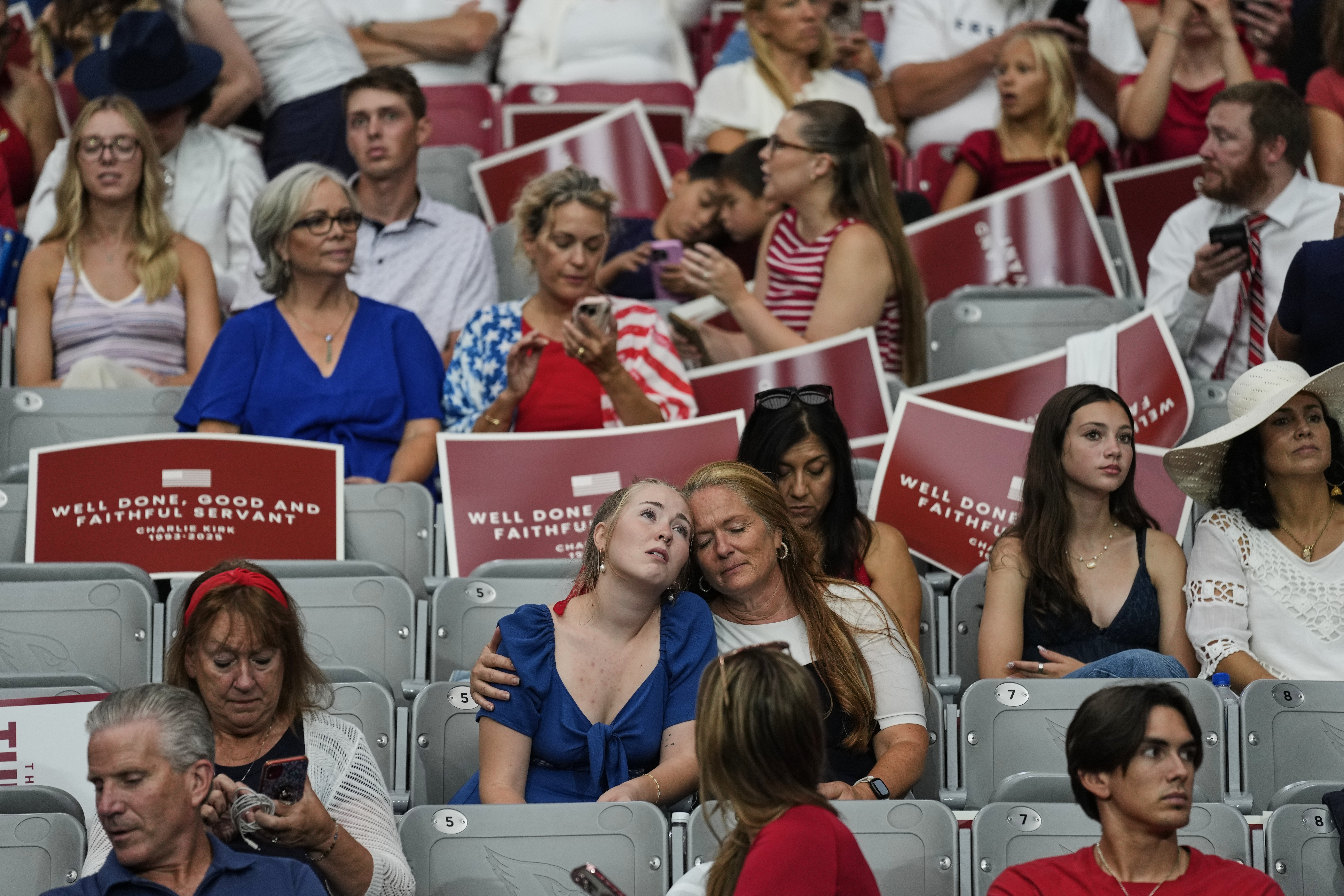 People sit inside before the start of a memorial for conservative activist Charlie Kirk, Sunday, Sept. 21, 2025, at State Farm Stadium in Glendale, Ariz. (John Locher - AP)