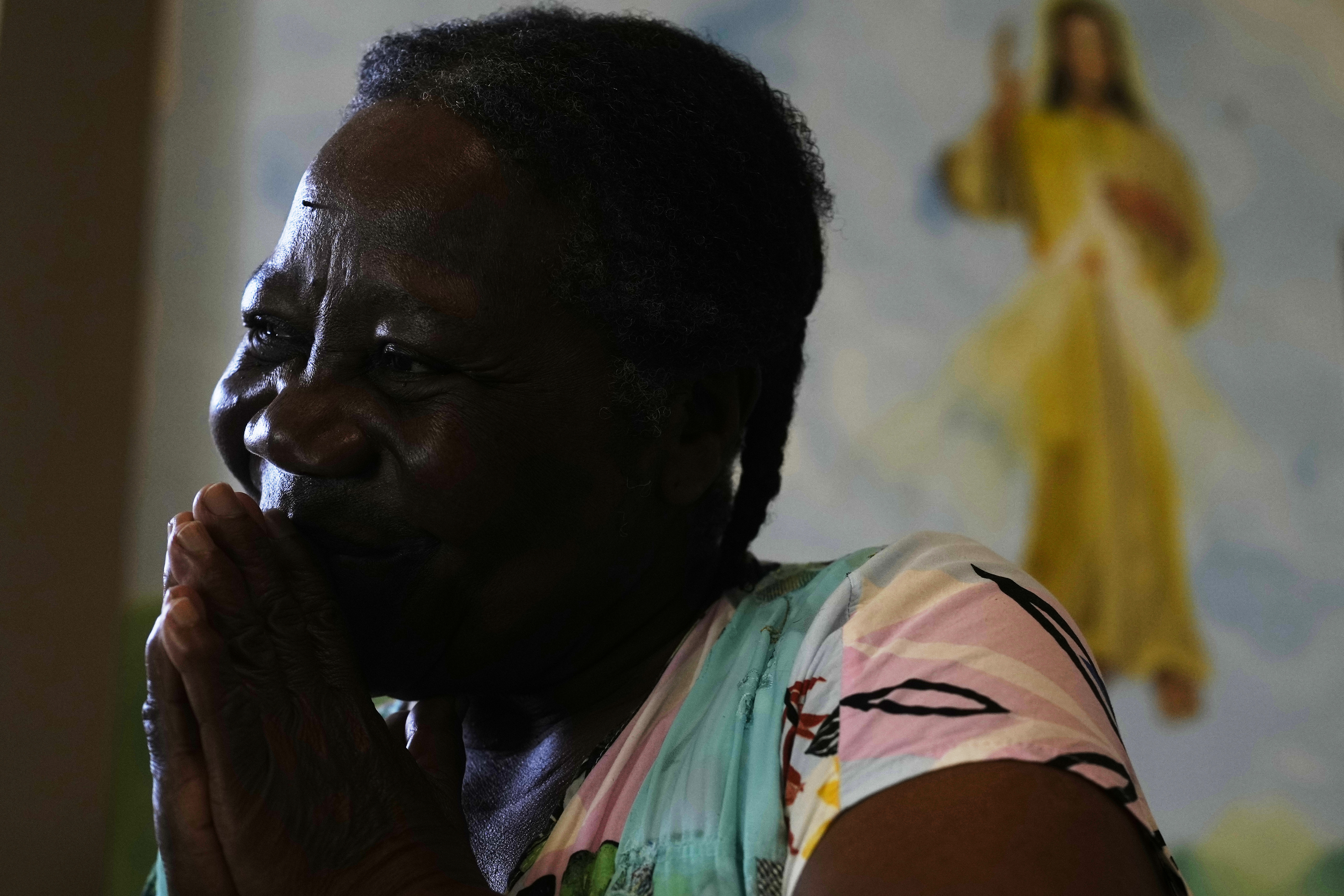 Antonia Pinedo prays inside the Catholic Church of Mururata, Bolivia, Sunday, Aug. 3, 2025. (Juan Karita - AP)