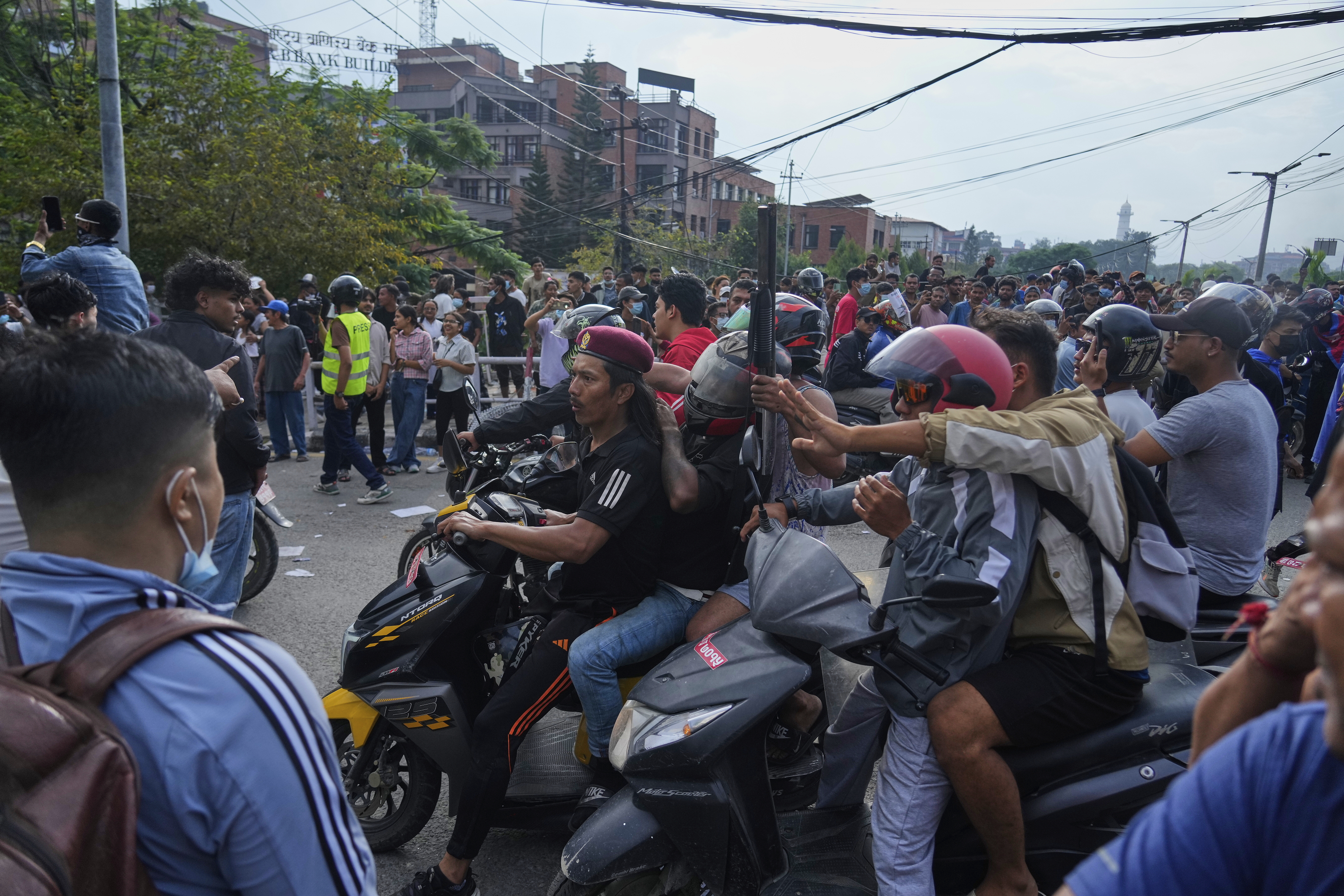 A protester rides on two wheelers carrying a firearm with others during a protest against a social media ban and corruption in Kathmandu, Nepal, Tuesday, Sept. 9, 2025. (Niranjan Shrestha - AP)