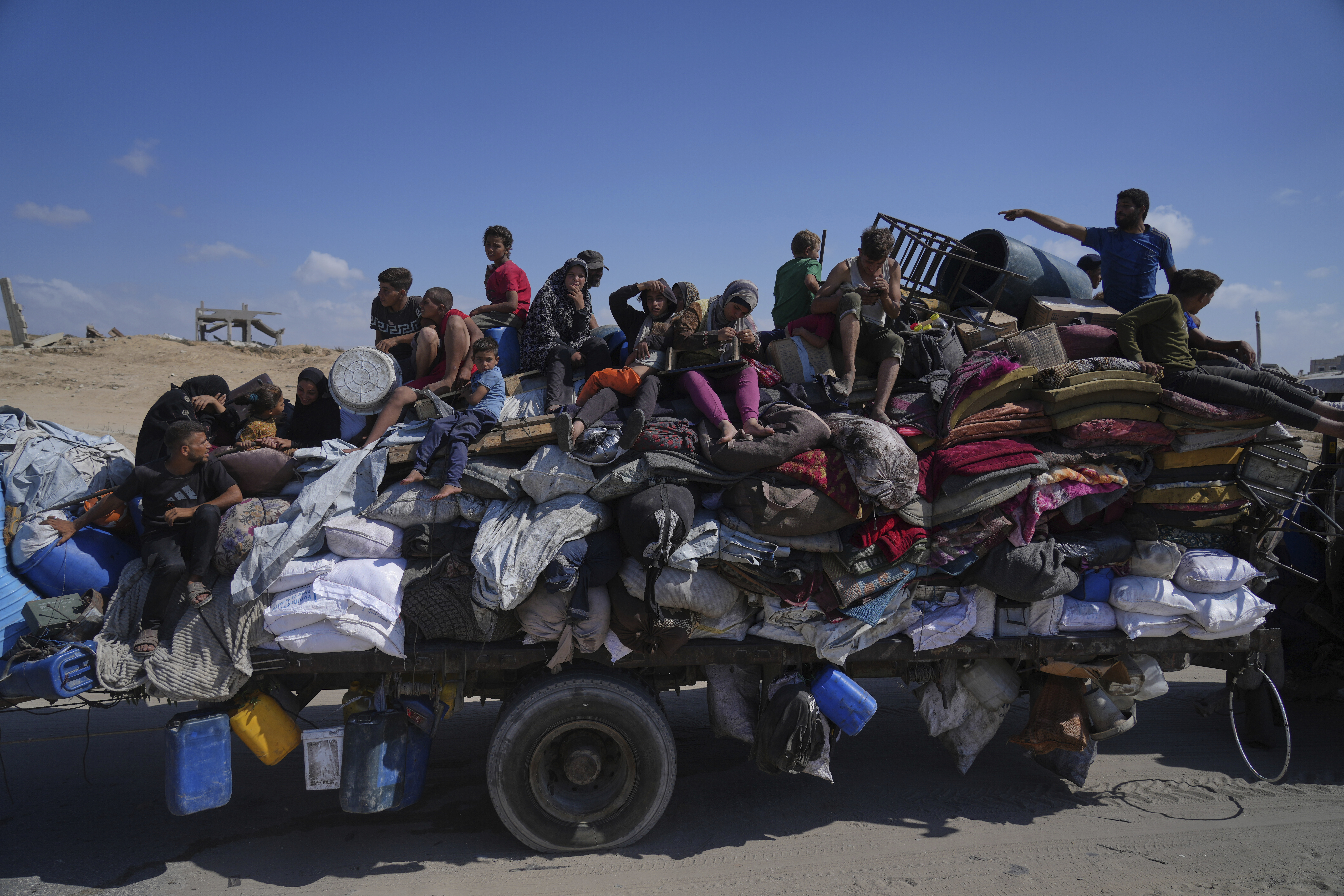 Displaced Palestinians fleeing northern Gaza carry their belongings along the coastal road toward southern Gaza, Tuesday, Sept. 9, 2025, after the Israeli army issued evacuation orders from Gaza City. (Jehad Alshrafi - AP)