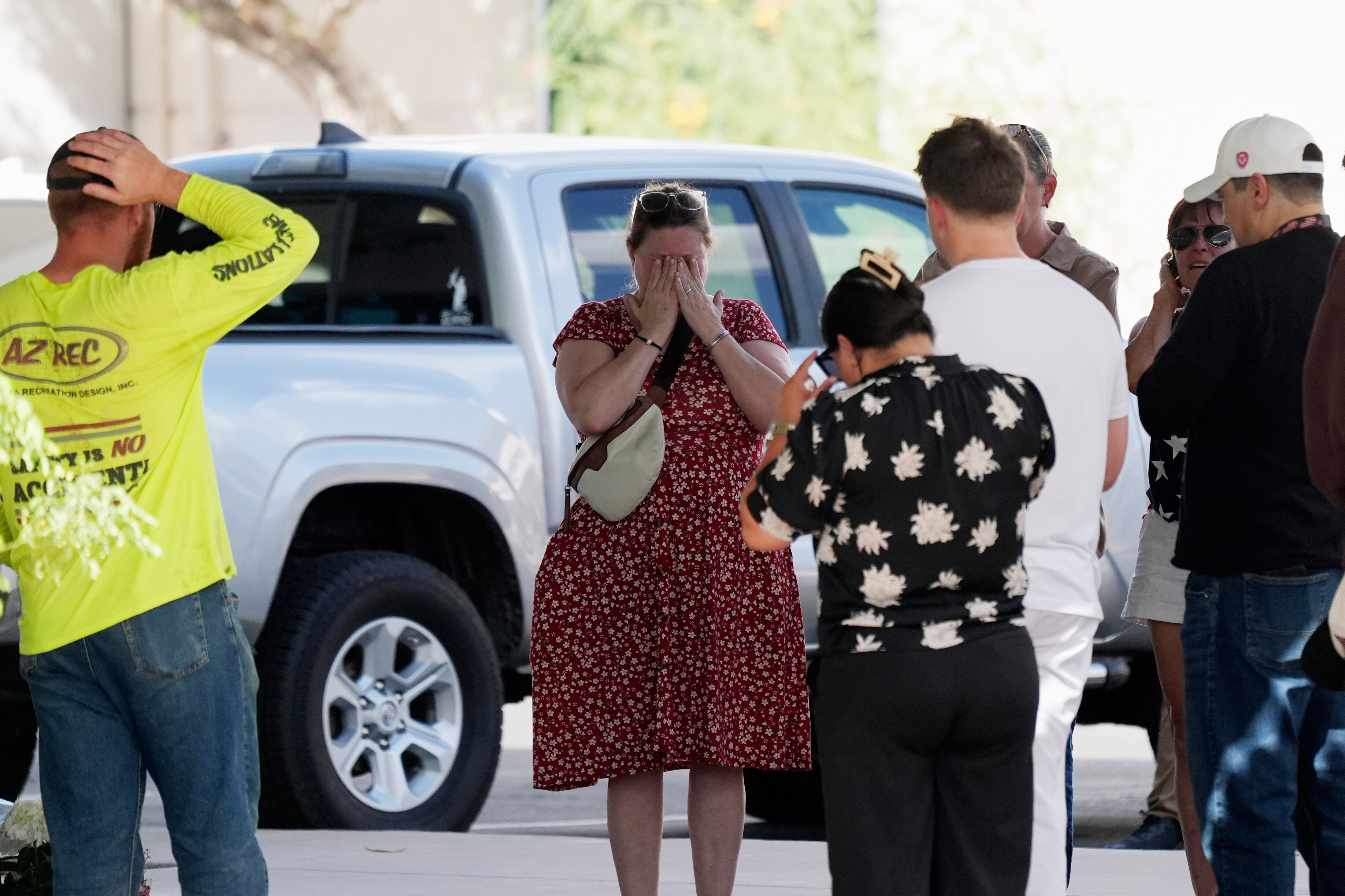 Well-wishers pray at the national headquarters of Turning Point USA shown after the shooting death of Charlie Kirk, the co-founder and CEO of the organization, during a Utah college event, Wednesday, Sept. 10, 2025, in Phoenix. (Ross D. Franklin - AP)