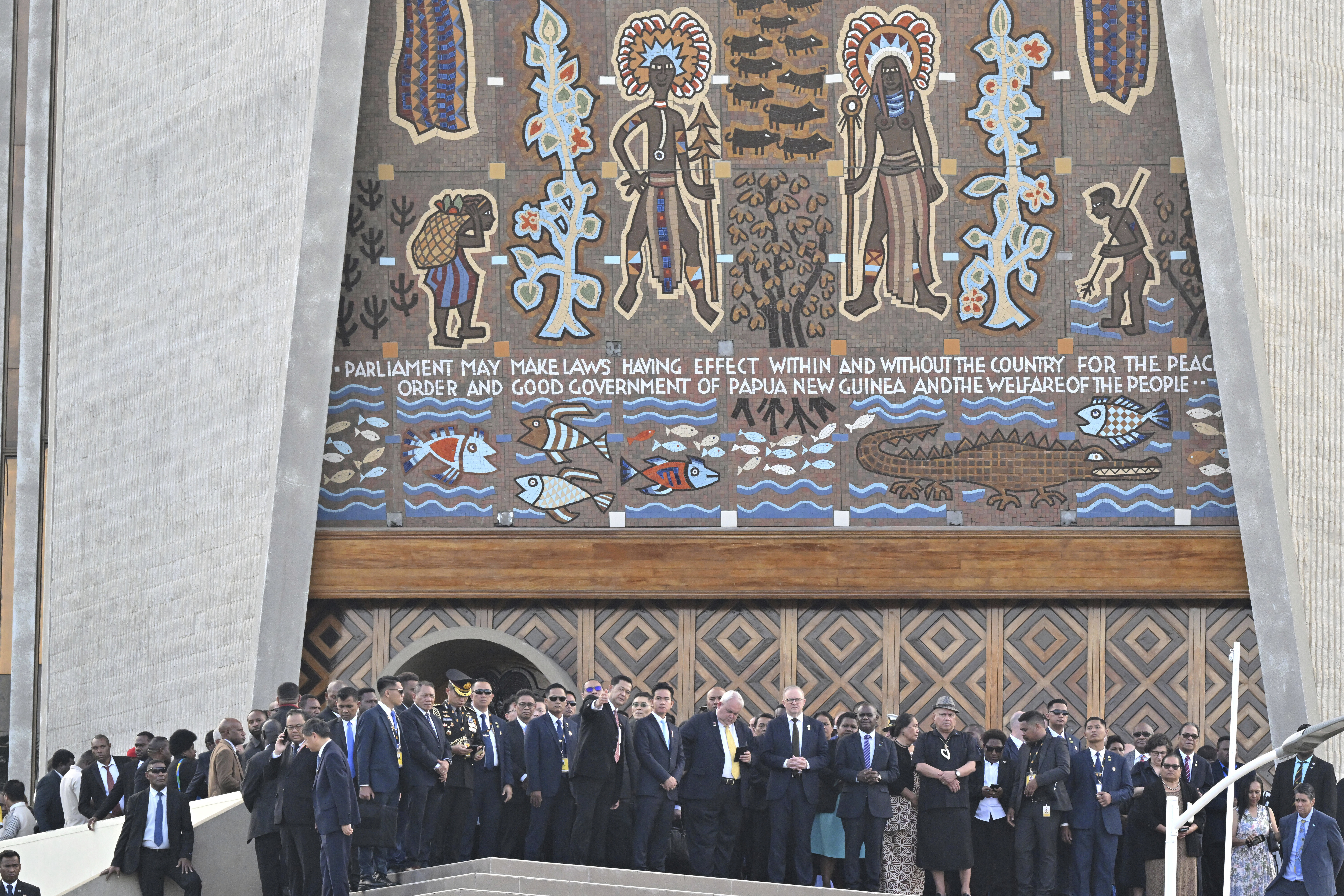 Australian Prime Minister Anthony Albanese, center right, and other dignitaries stand in front of Parliament House after a flag raising ceremony in Port Moresby, Papua New Guinea, Tuesday, Sept. 16, 2025. (Mick Tsikas - AAP Image)