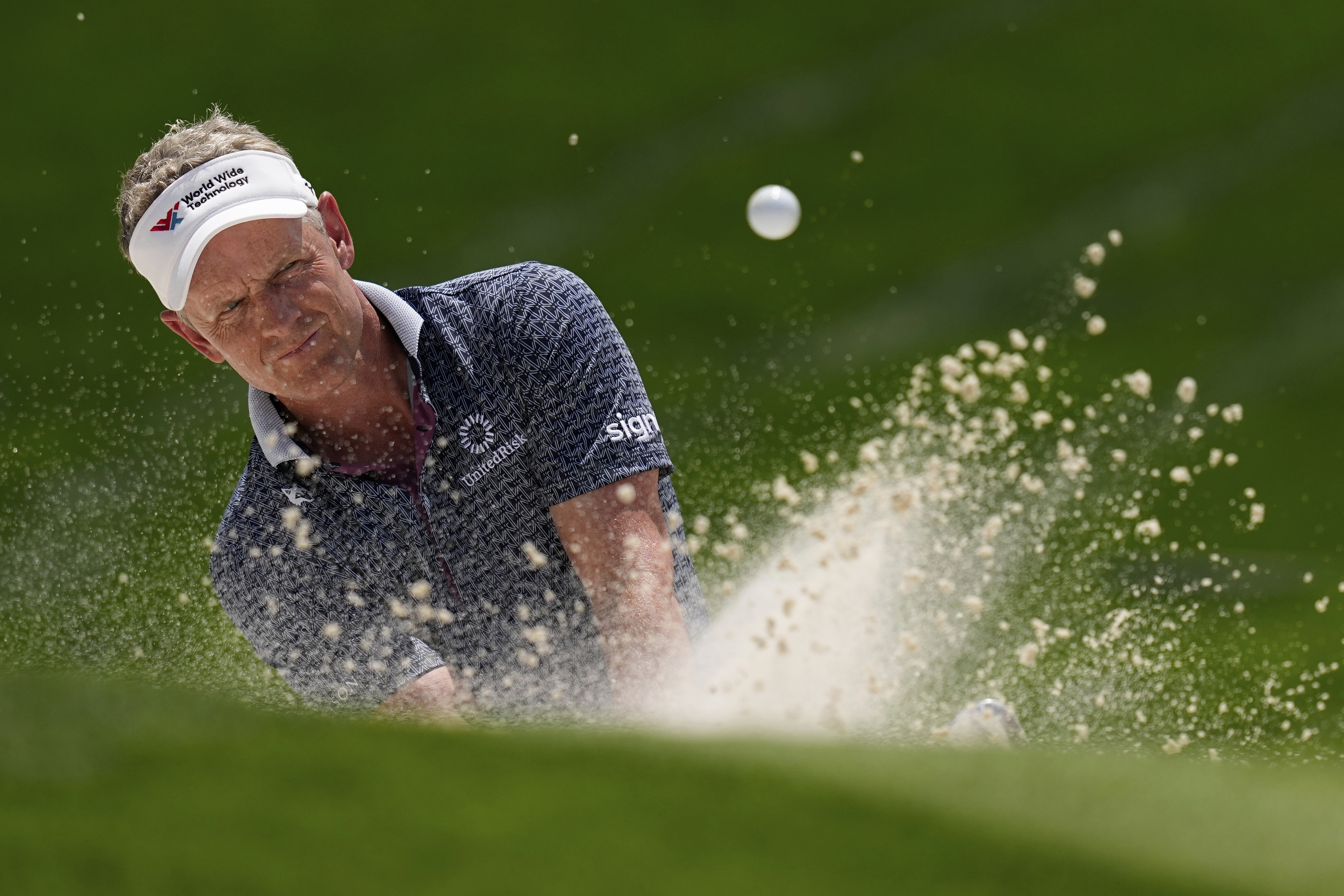 FILE - Luke Donald, of England, hits from the bunker on the 18th hole during the first round of the PGA Championship golf tournament at the Quail Hollow Club, Thursday, May 15, 2025, in Charlotte, N.C. (David J. Phillip - AP)