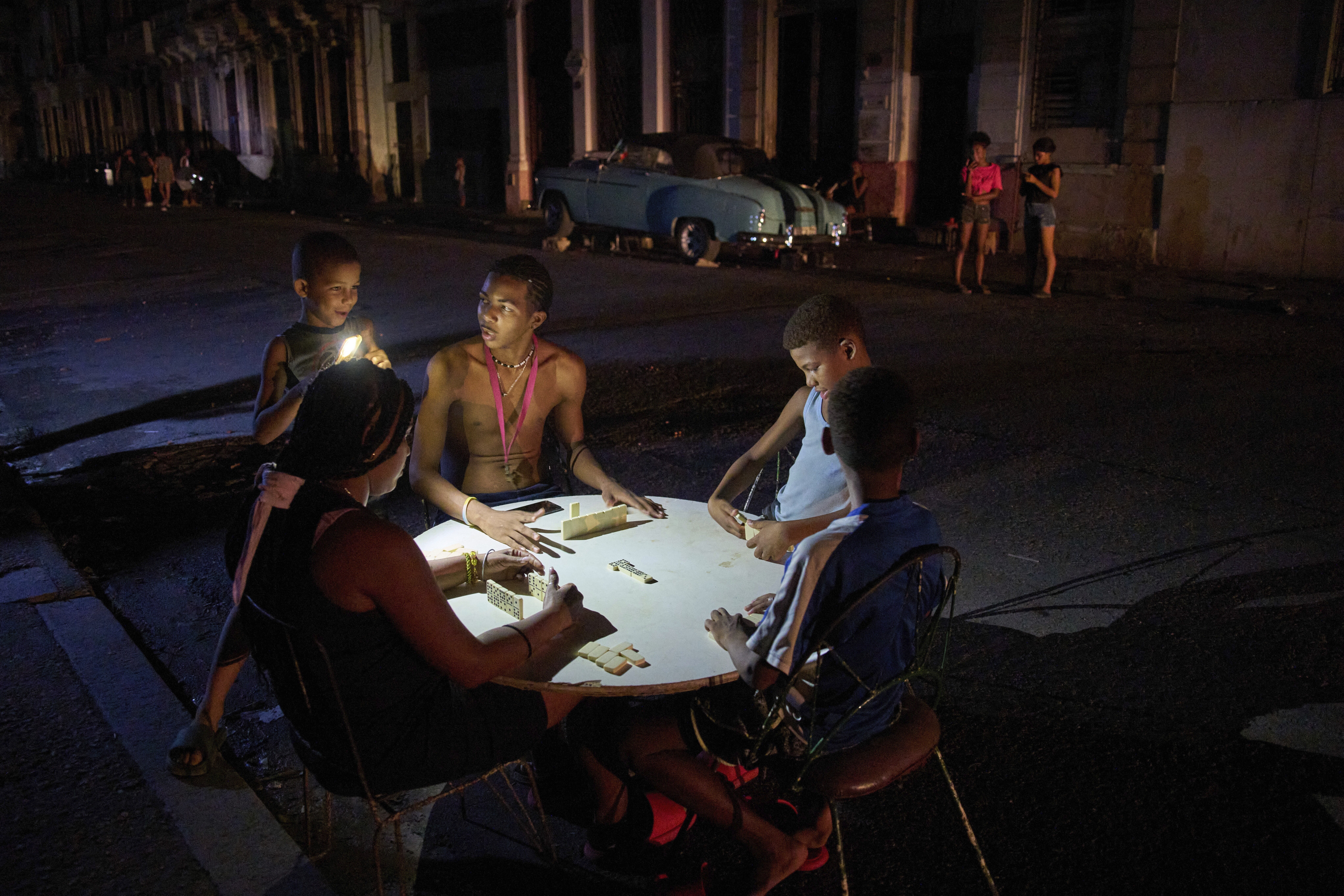 People play dominoes on the street during a blackout in Havana, Wednesday, Sept. 10, 2025. (Ramon Espinosa - AP)