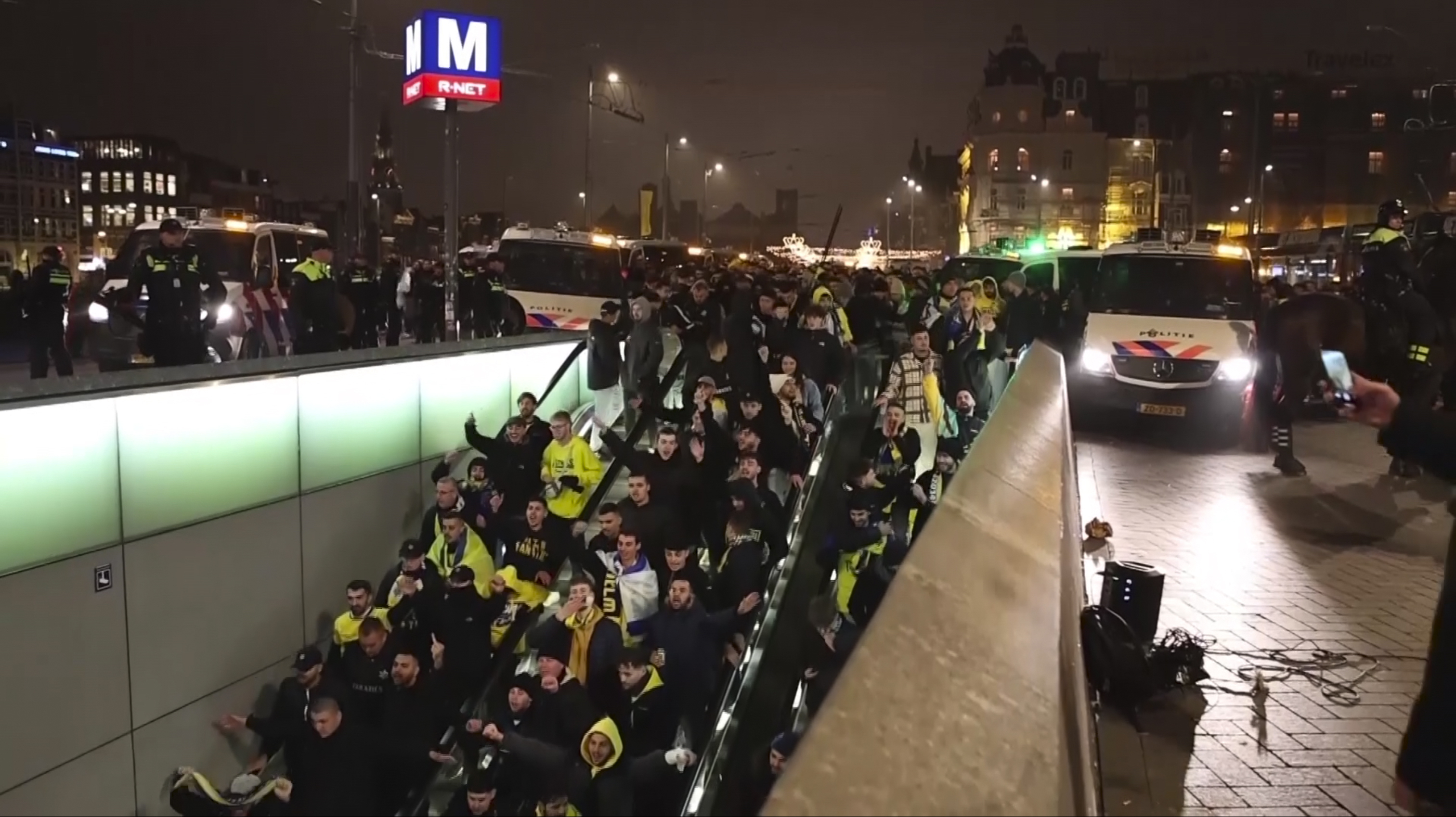 FILE - In this image taken from video, police escort Maccabi Tel Aviv supporters to the metro after pro-Palestinian supporters marched near the soccer stadium, Thursday, Nov. 7, 2024, in Amsterdam, the Netherlands, following the Europe League soccer match between Maccabi Tel Aviv and Ajax. (InterVision - AP)