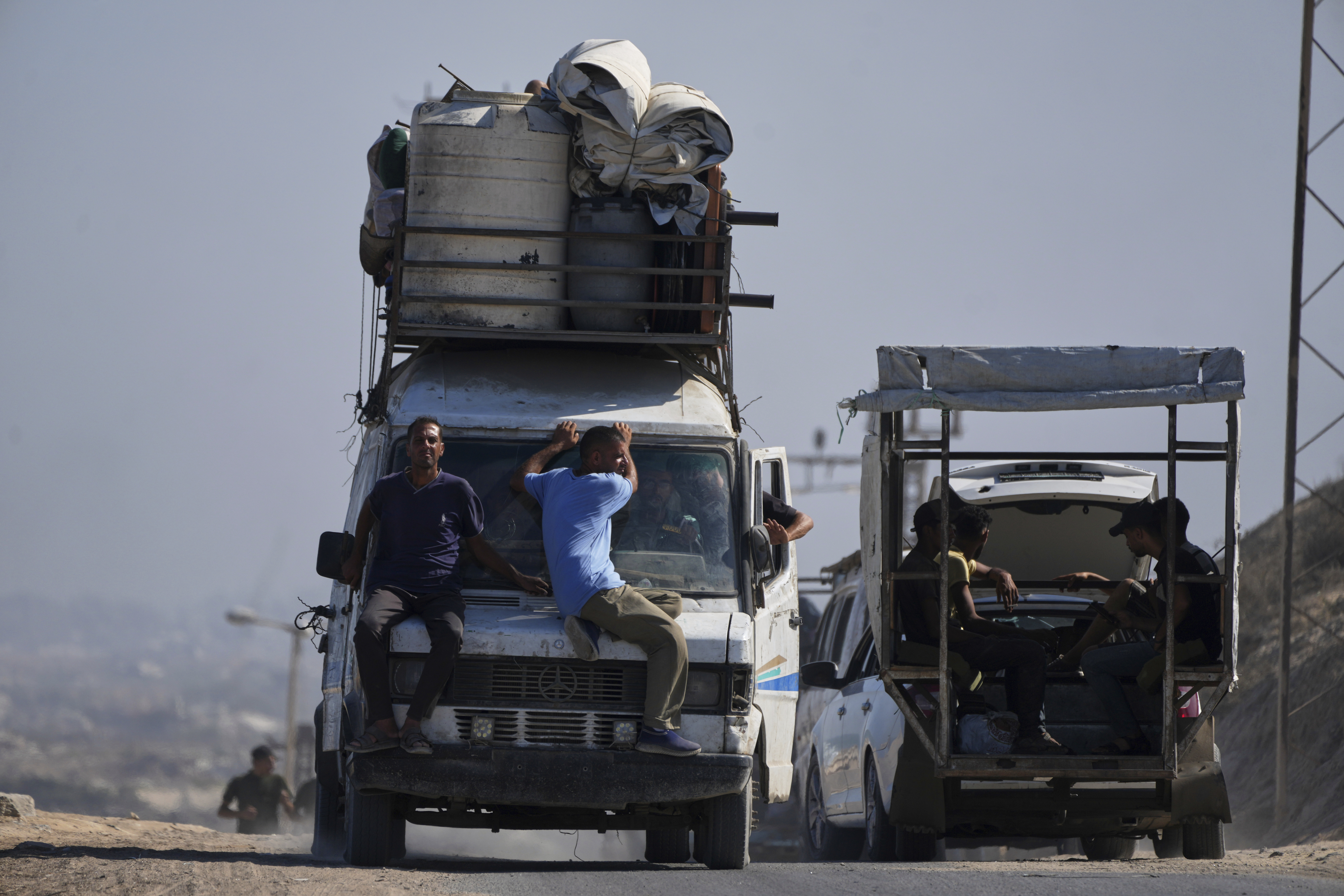 Displaced Palestinians fleeing northern Gaza carry their belongings along the coastal road toward southern Gaza, Tuesday, Sept. 9, 2025, after the Israeli army issued evacuation orders from Gaza City. (Jehad Alshrafi - AP)