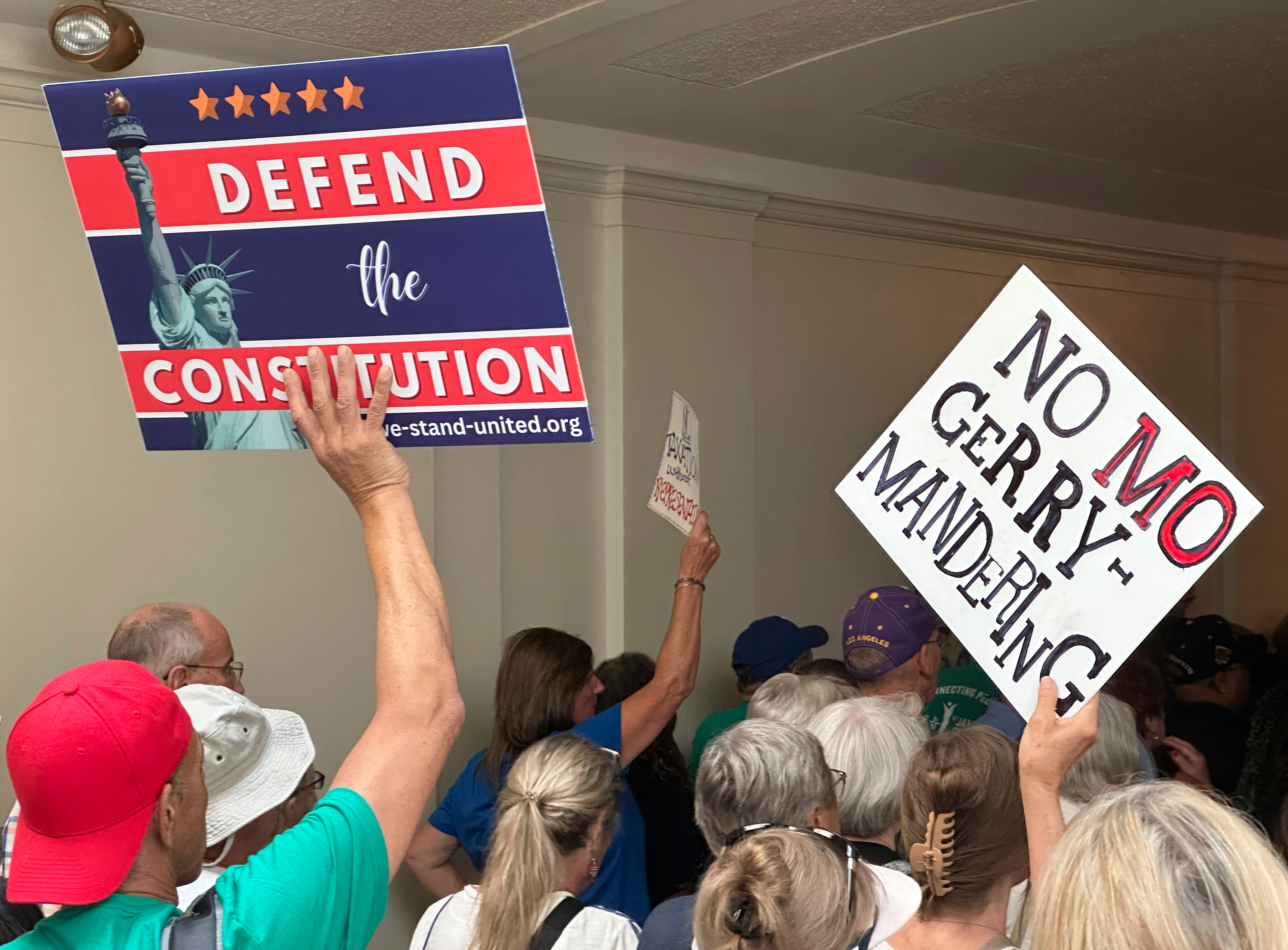 Opponents of a Republican plan to redraw Missouri's U.S. House districts march through a hallway outside the state Senate chamber in Jefferson City, Mo., Wednesday, Sept. 10, 2025. (David A. Lieb - AP)