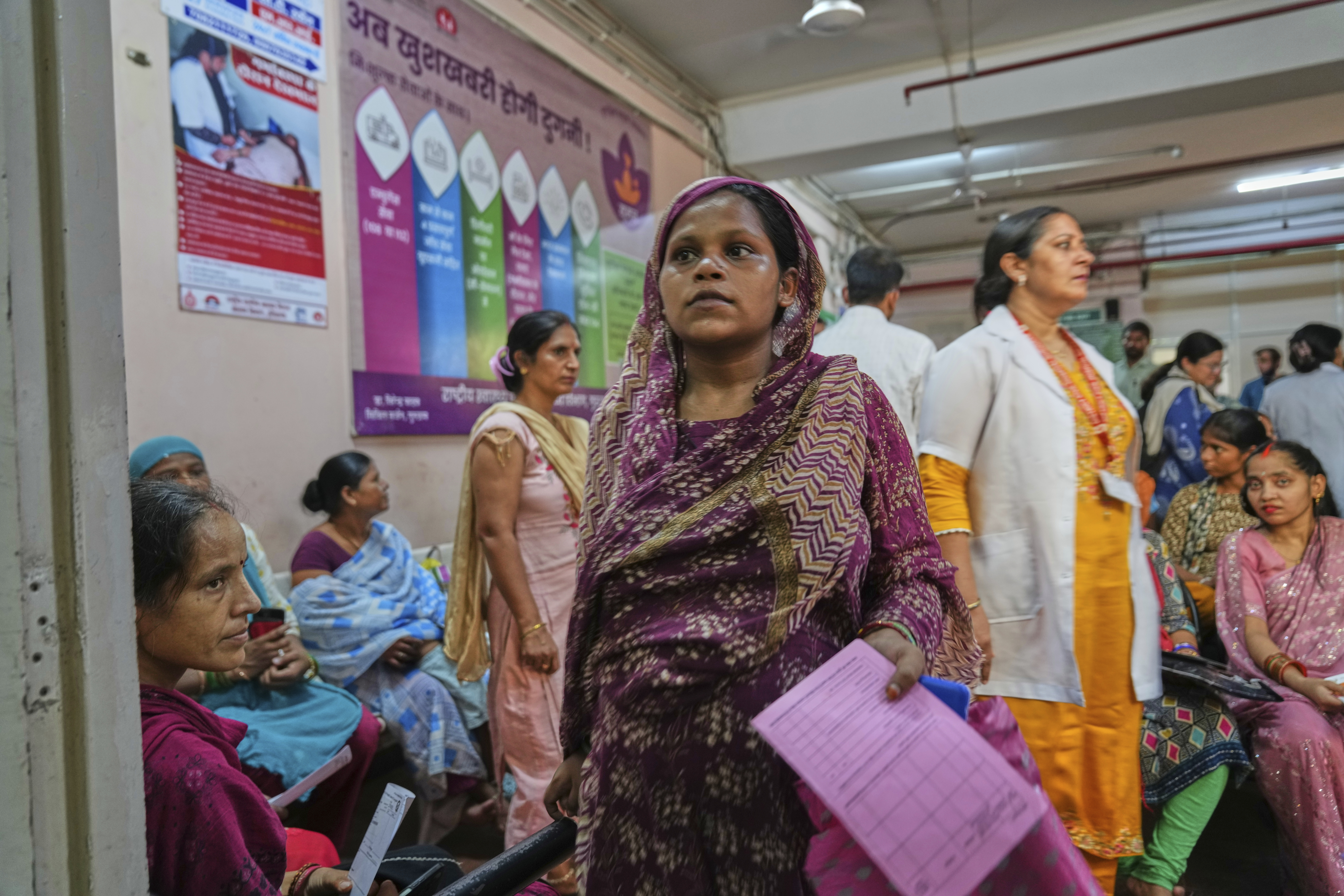 A pregnant woman walks for her routine check after attending an antenatal Care Companion Program (CCP) at a government hospital in Gurugram, a satellite city of New Delhi, India, on Aug. 7, 2025. (Manish Swarup - AP)