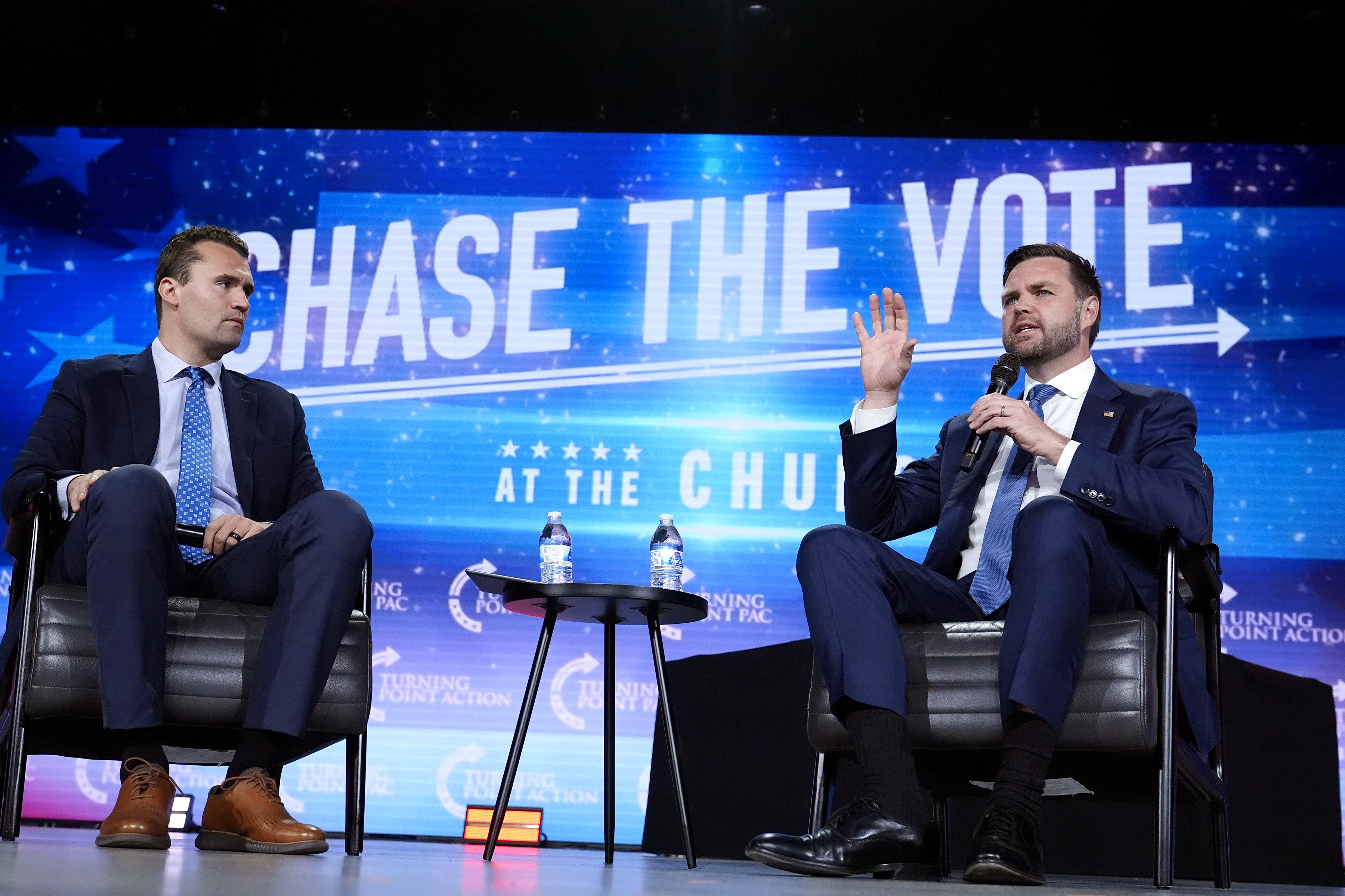 FILE - Republican vice presidential nominee Sen. JD Vance, R-Ohio, right, speaks at a campaign event as Turning Point USA Founder Charlie Kirk, left, listens, Wednesday, Sept. 4, 2024, in Mesa, Ariz. (Ross D. Franklin - AP)