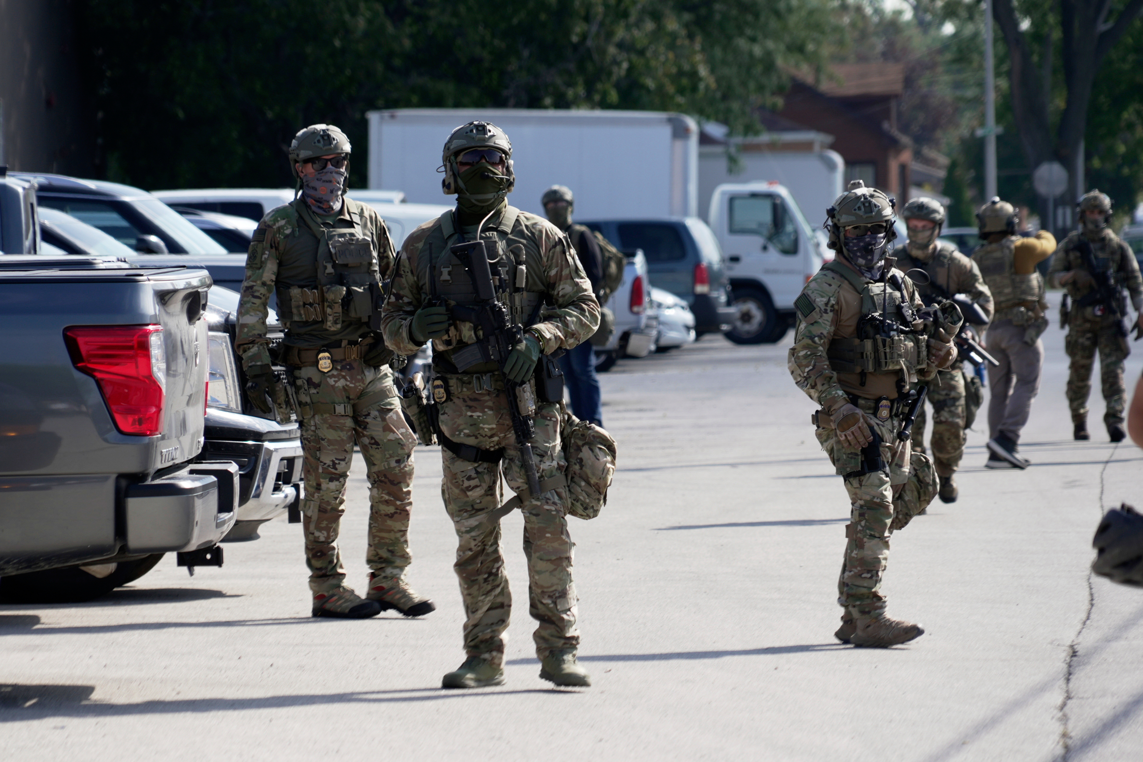 Federal agents stand guard as a planned protest starts outside of an immigration facility in Broadview, Ill. Friday, Sept. 12, 2025. (Laura Bargfeld - AP)