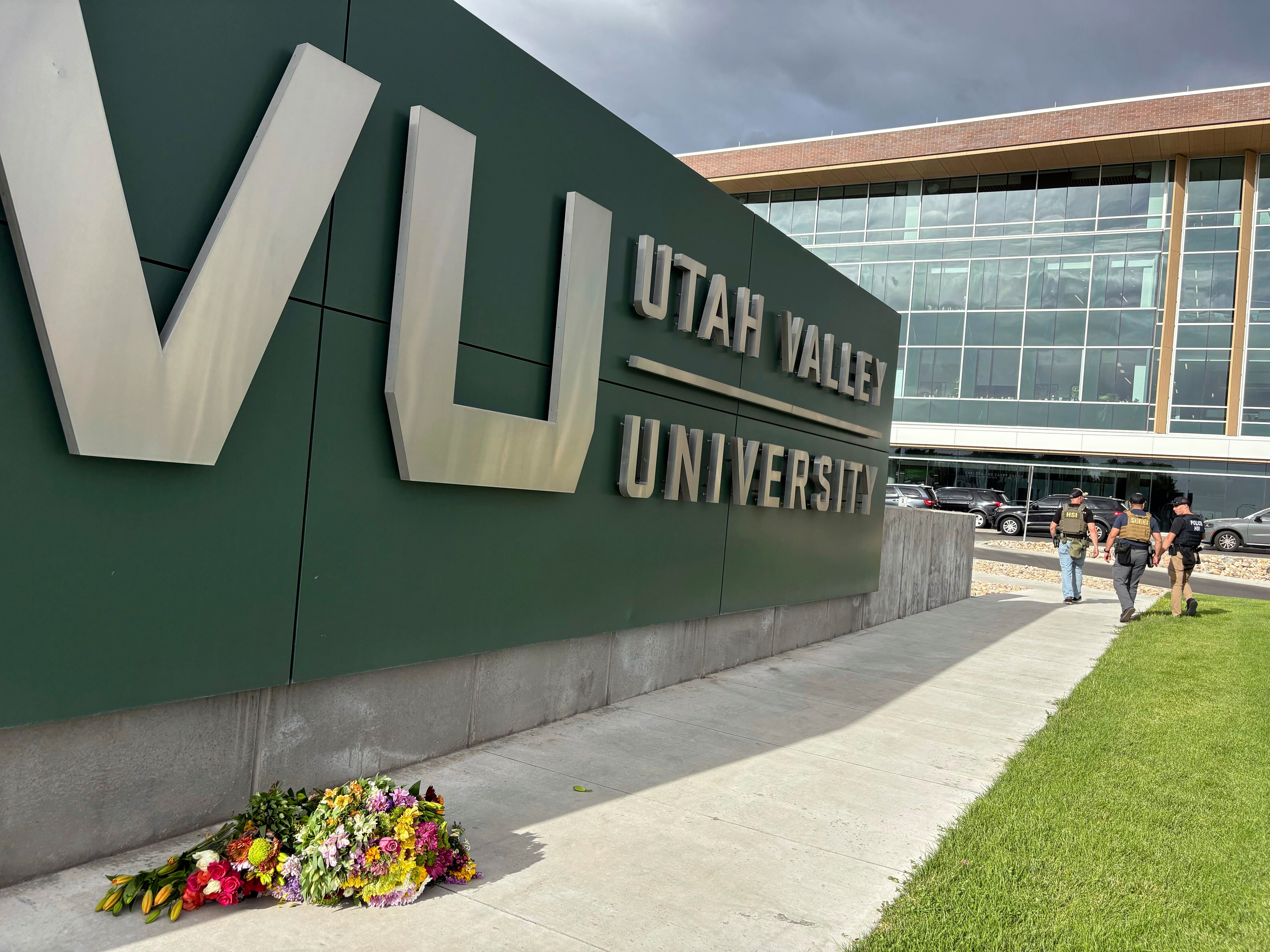 Flowers are shown outside the Keller Building on the Utah Valley University campus as police walk nearby after Charlie Kirk was shot and died during Turning Point's visit to the university, Wednesday, Sept. 10, 2025, in Orem, Utah. (Hannah Schoenbaum - AP)