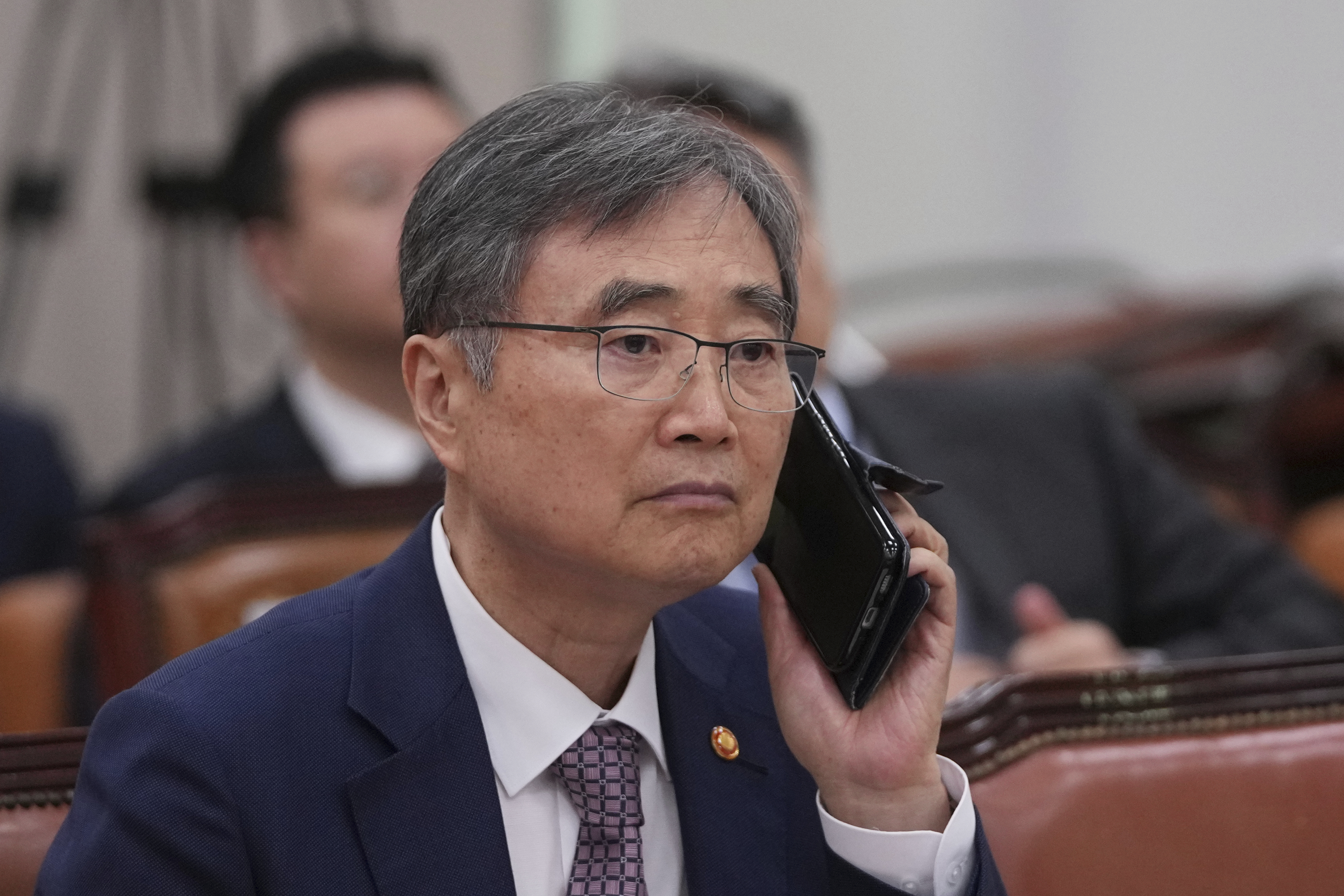 South Korean Foreign Minister Cho Hyun holds his mobile phone before a session of the Foreign Affairs and Unification Committee at the National Assembly in Seoul, South Korea, Monday, Sept. 8, 2025. (Lee Jin-man - AP)