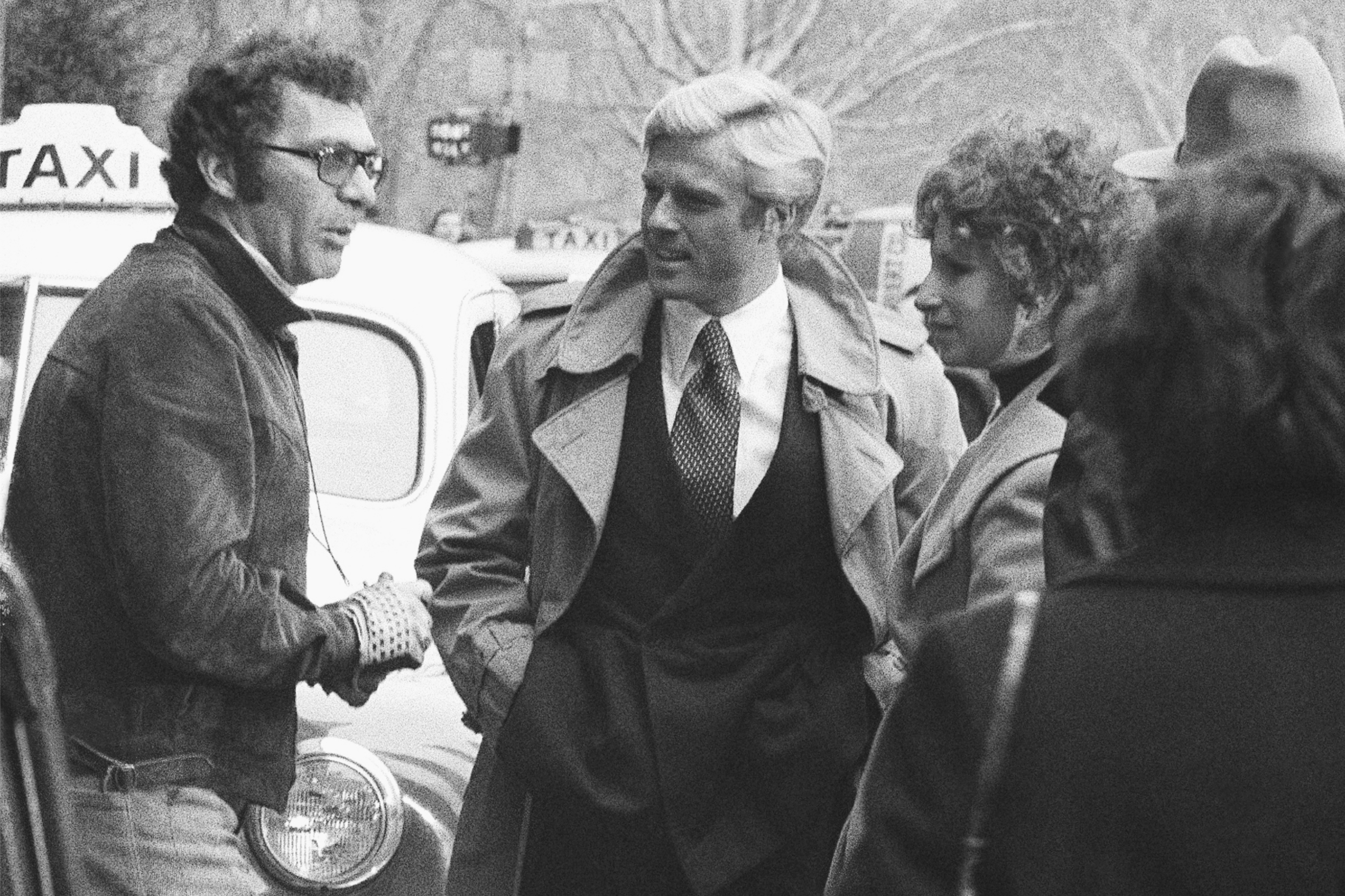 FILE - Director Sydney Pollack, left, appears with actors Robert Redford, center, and Barbra Streisand during the filming of