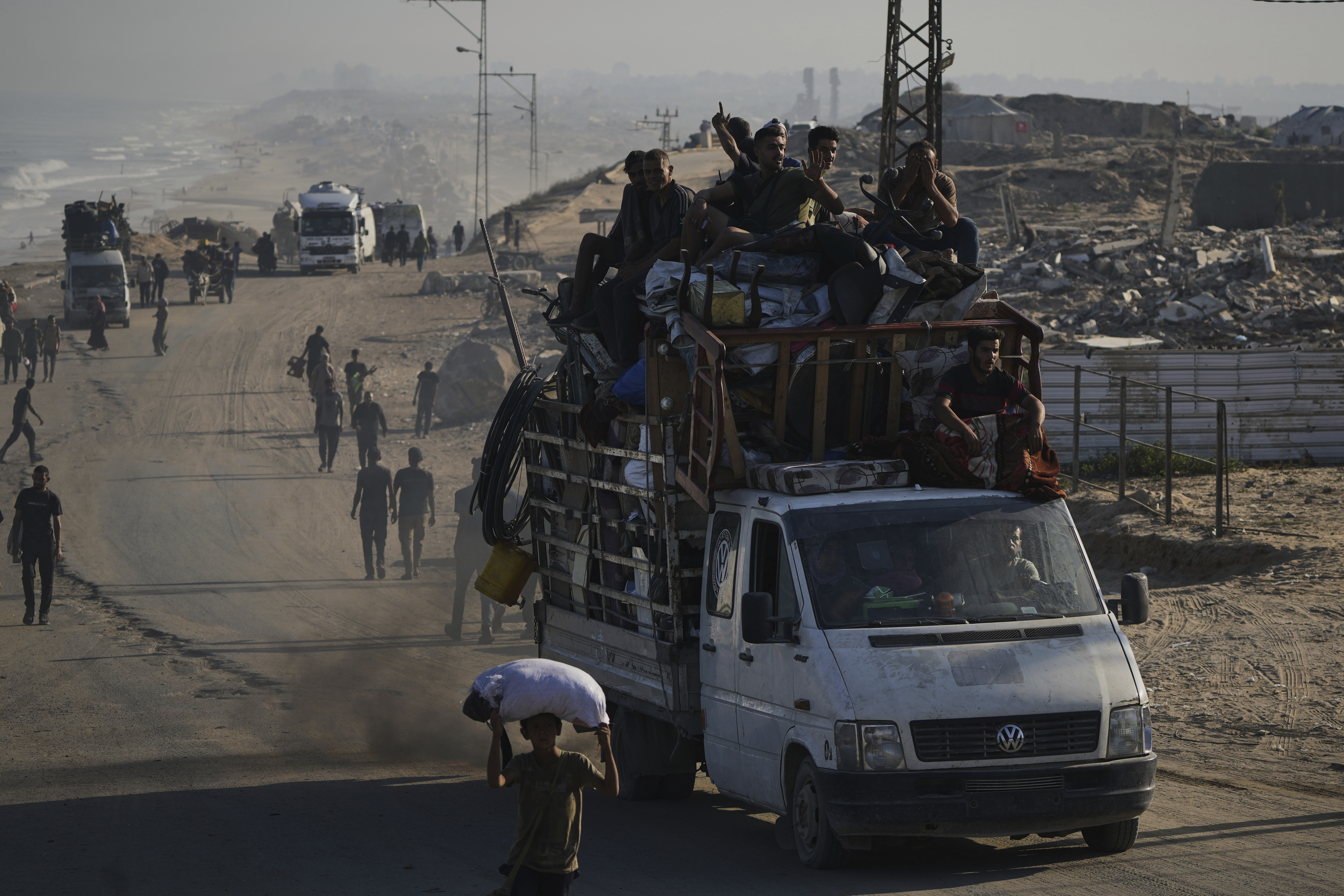 Displaced Palestinians flee Gaza City by foot and vehicles, carrying their belongings along the coastal road toward southern Gaza, Wednesday, Sept. 17, 2025. (Abdel Kareem Hana - AP)