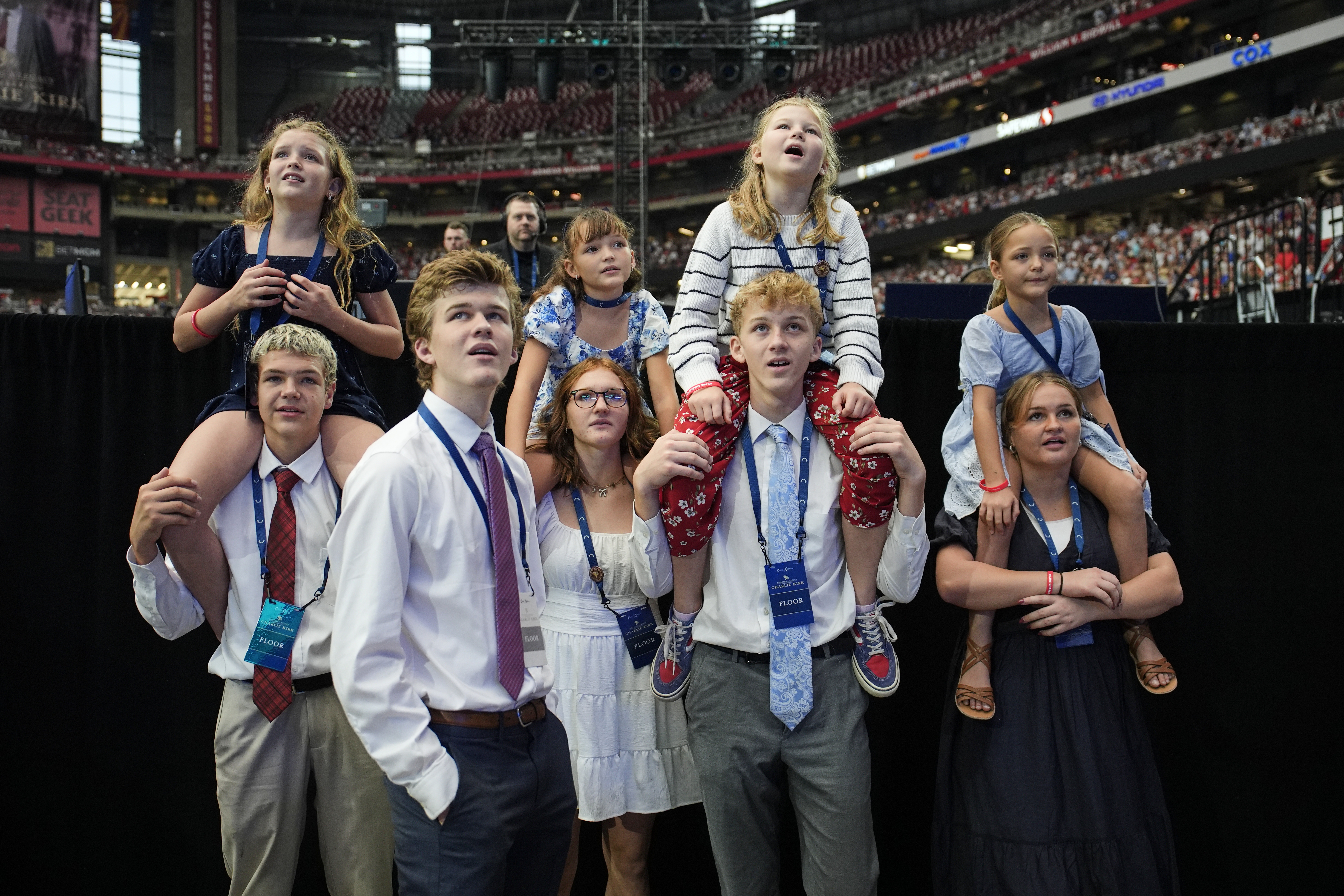 People watch as a band performs before the start of a memorial for conservative activist Charlie Kirk, Sunday, Sept. 21, 2025, at State Farm Stadium in Glendale, Ariz. (John Locher - AP)