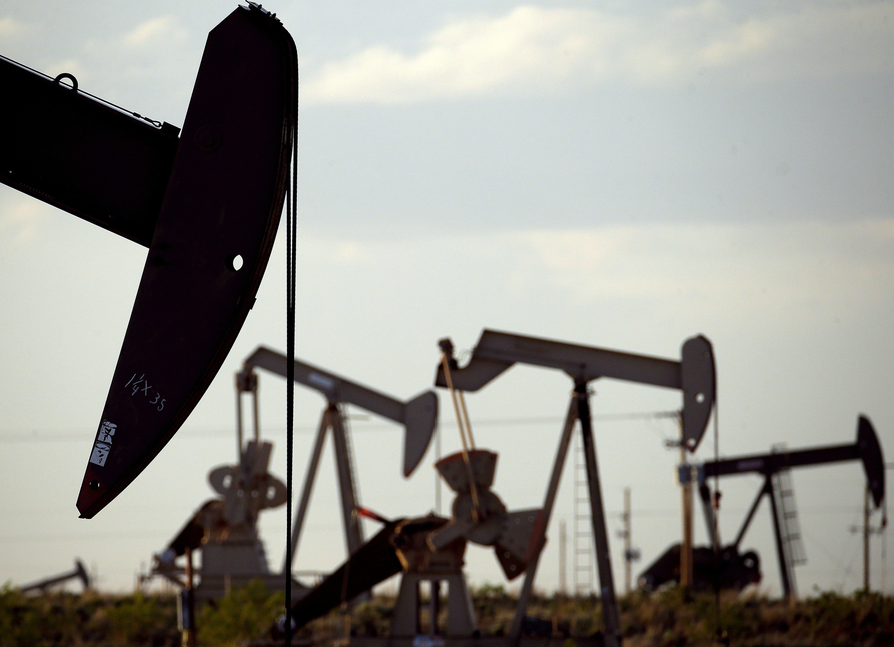 FILE - Pumpjacks work in a field near Lovington, N.M., on April 24, 2015. (Charlie Riedel - AP)
