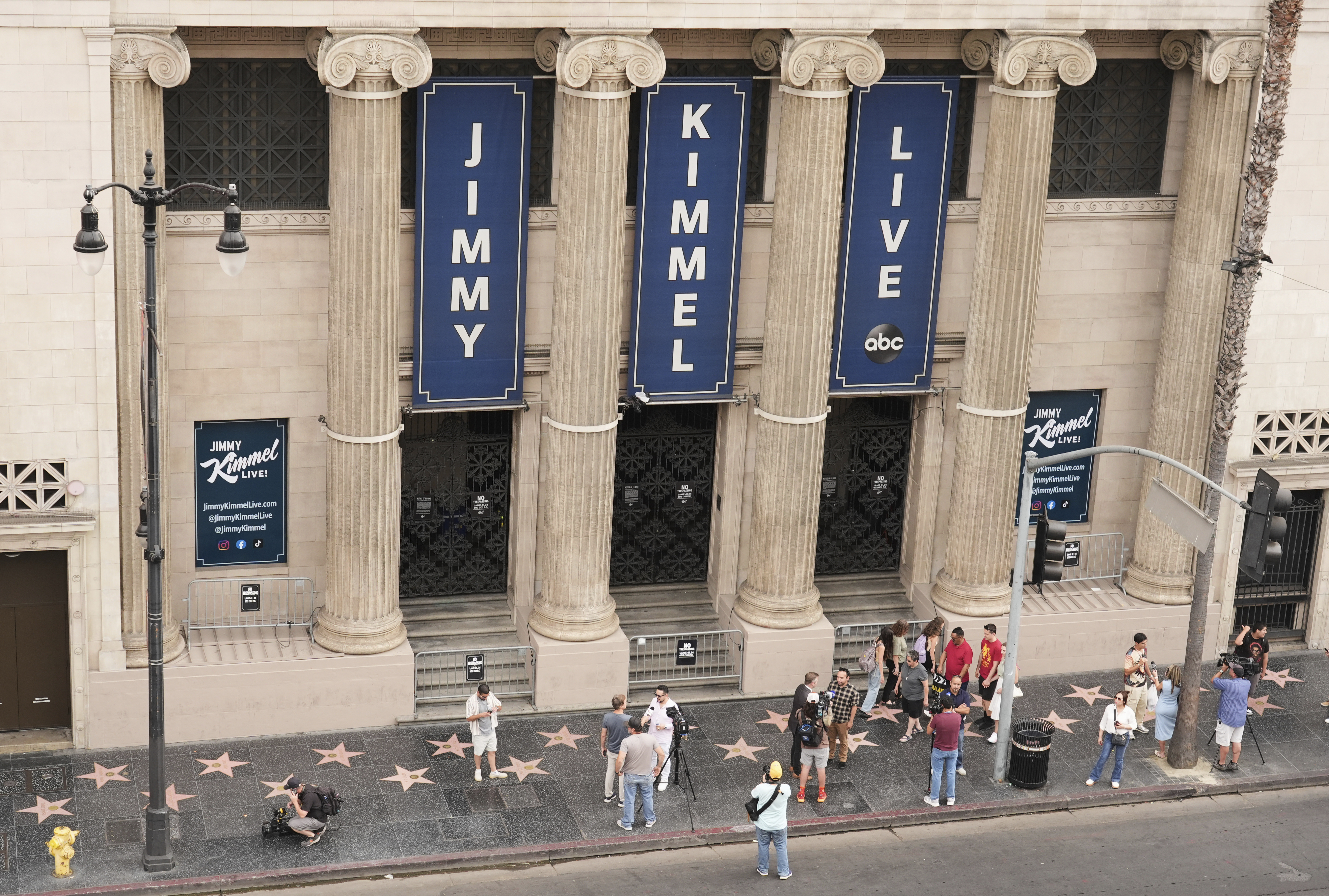 Pedestrians and media gather in front of the Jimmy Kimmel Live studio on Hollywood Blvd., Wednesday, Sept. 17, 2025, in Los Angeles. (Chris Pizzello - Invision)