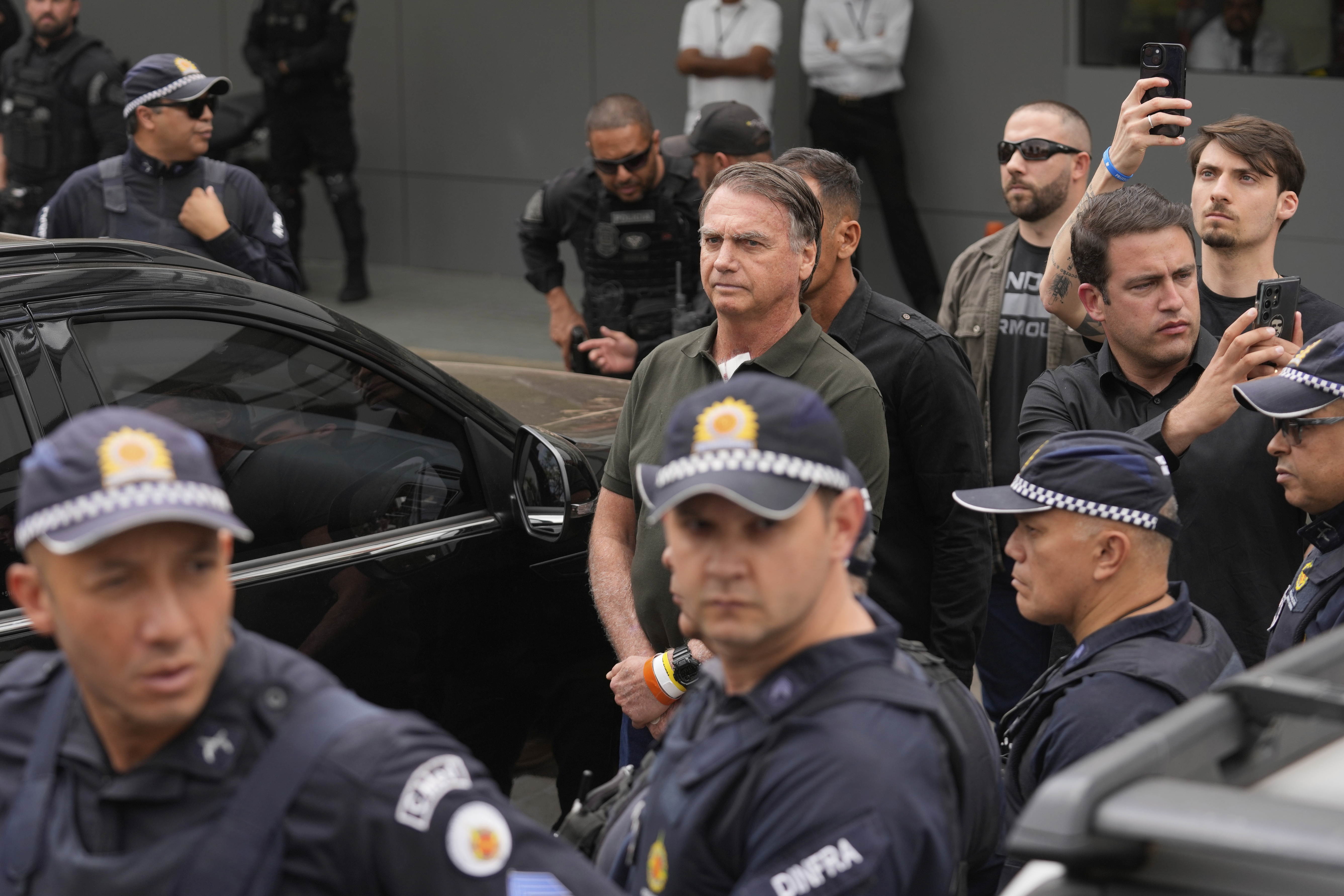 Former President Jair Bolsonaro, center, temporarily allowed out of house arrest for medical treatment, departs a hospital in Brasilia, Brazil, Sunday, Sep. 14, 2025. (Eraldo Peres - AP)