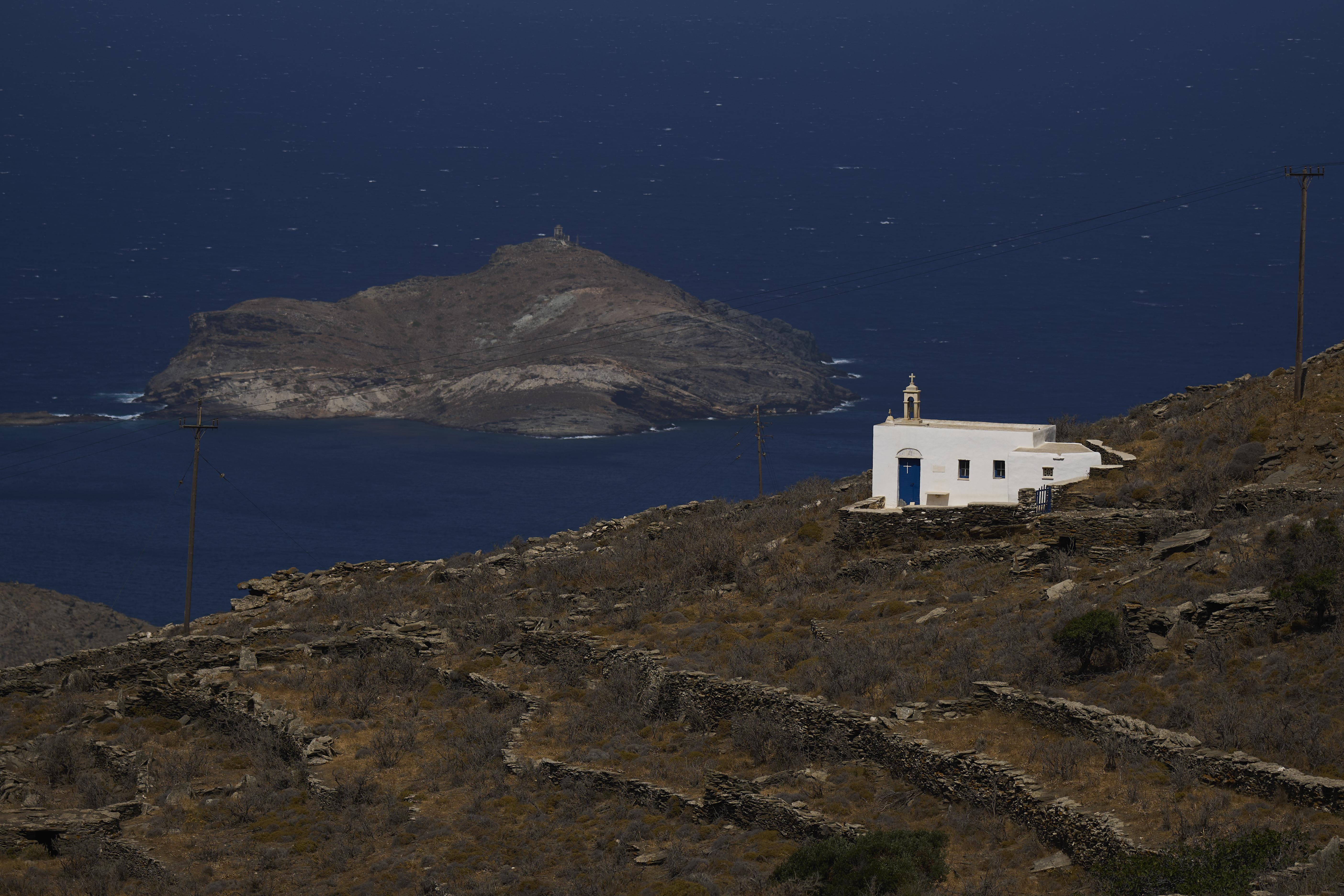 A family-owned chapel on the island of Tinos, Greece, with the isle of Planitis in the background, is seen on Saturday, Sept. 6, 2025. (Petros Giannakouris - AP)