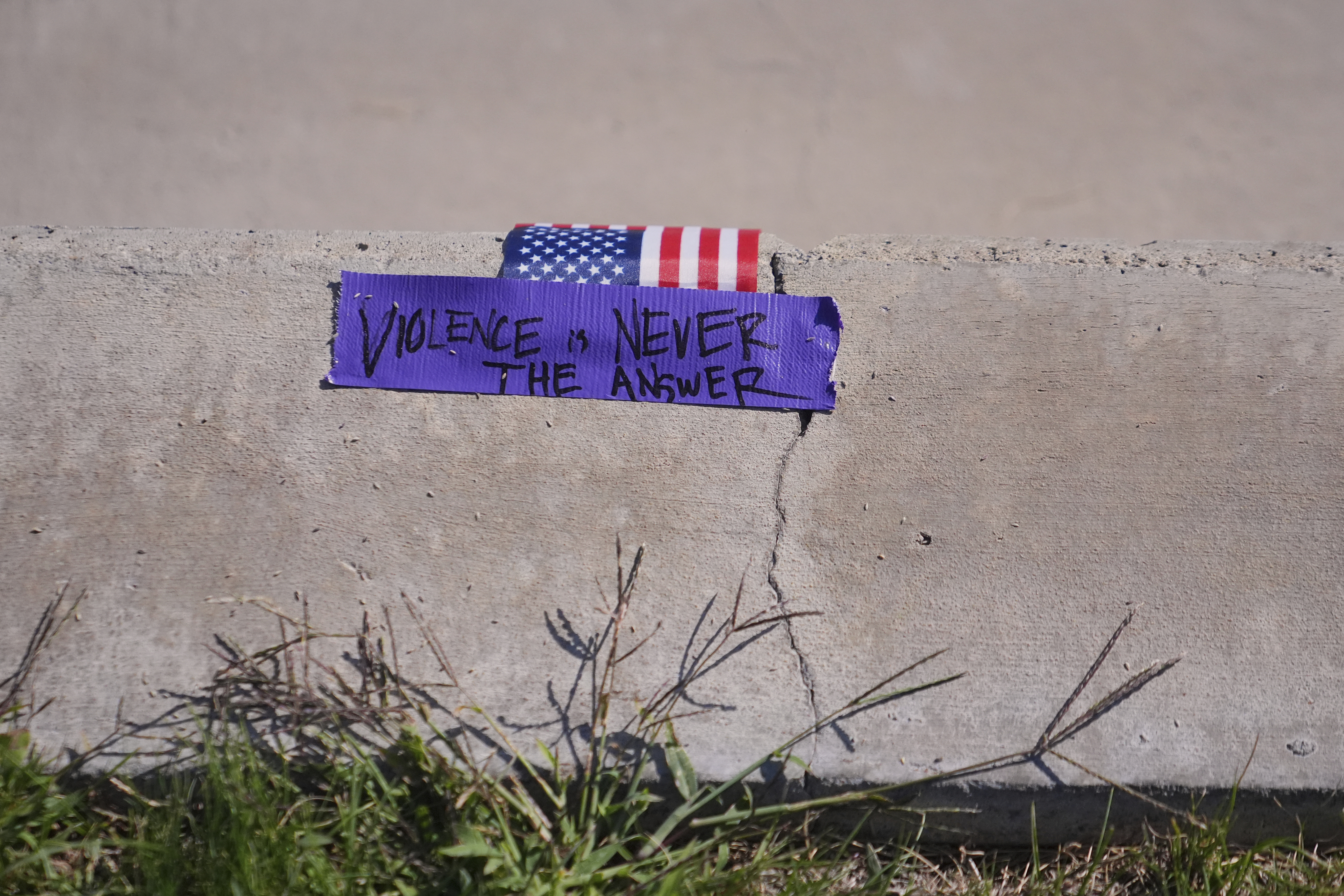 A note is left behind outside campus a day after the shooting of Charlie Kirk at Utah Valley University in Orem, Utah, Thursday, Sept. 11, 2025. (Lindsey Wasson - AP)