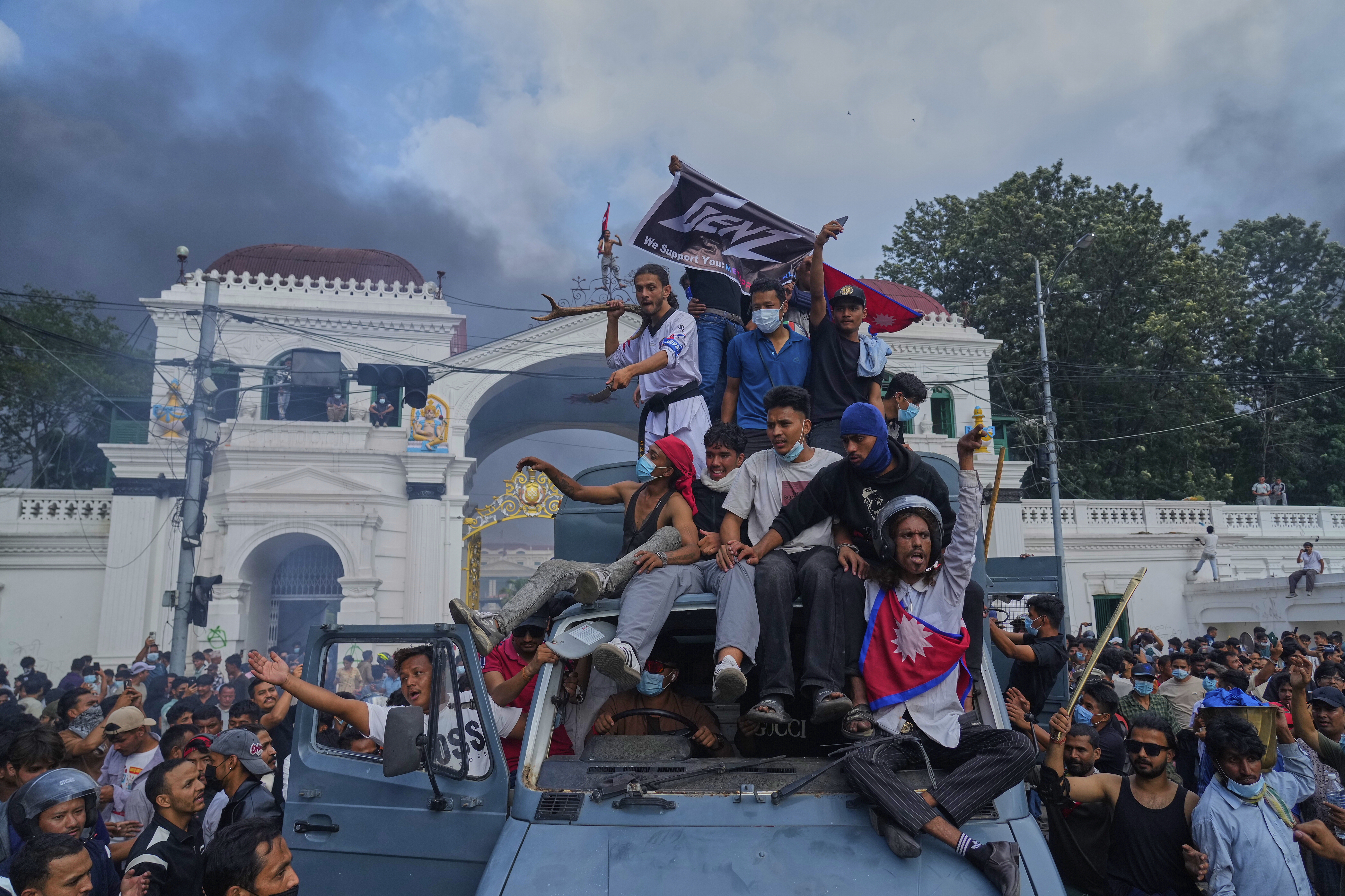 Protesters celebrate at the Singha Durbar, the seat of Nepal's government's various ministries and offices, after burning it down during a protest against a social media ban and corruption in Kathmandu, Nepal, Tuesday, Sept. 9, 2025. (Niranjan Shrestha - AP)