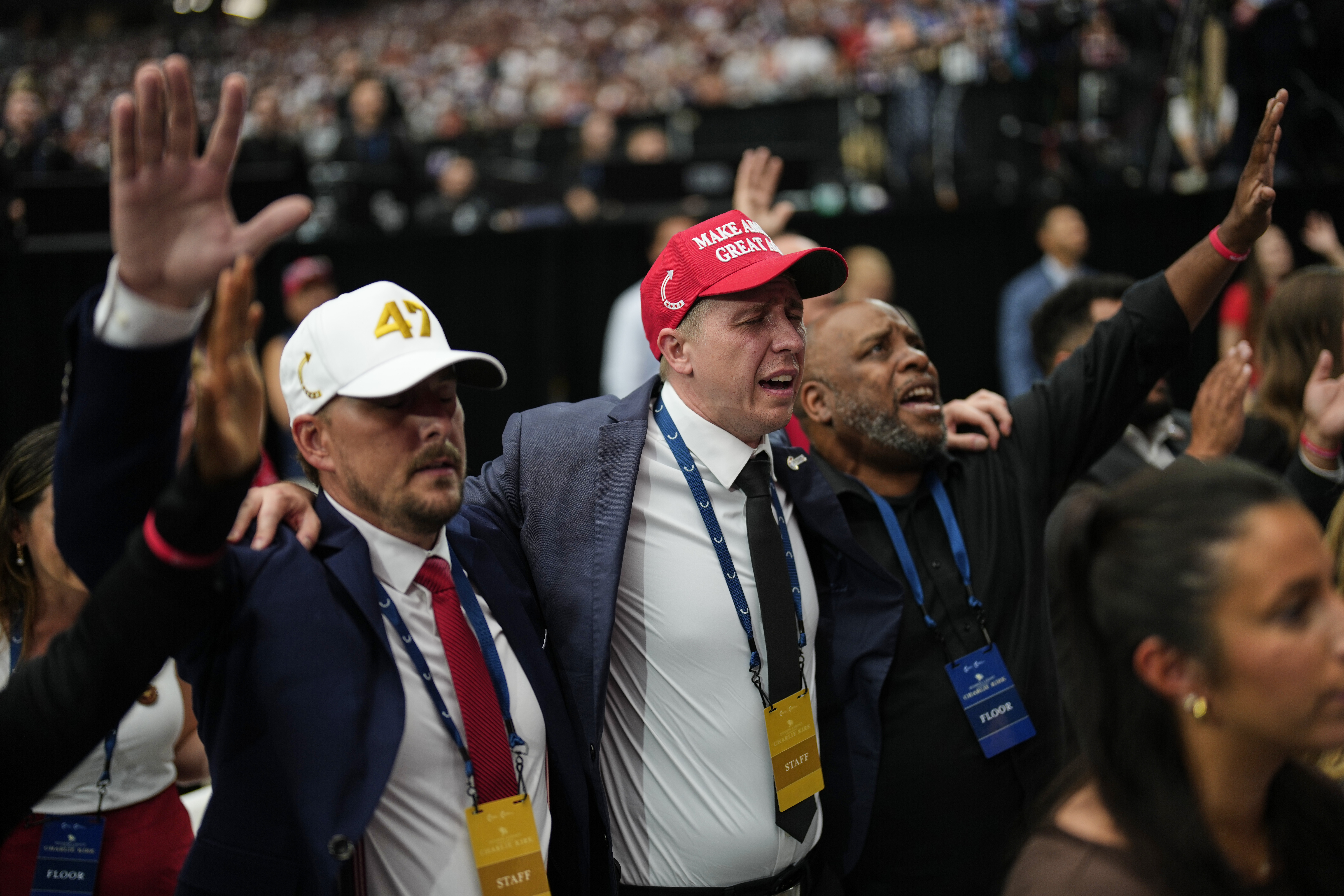 People are overcome with emotion while watching a Charlie Kirk tribute video during a memorial for the conservative activist Sunday, Sept. 21, 2025, at State Farm Stadium in Glendale, Ariz. (John Locher - AP)
