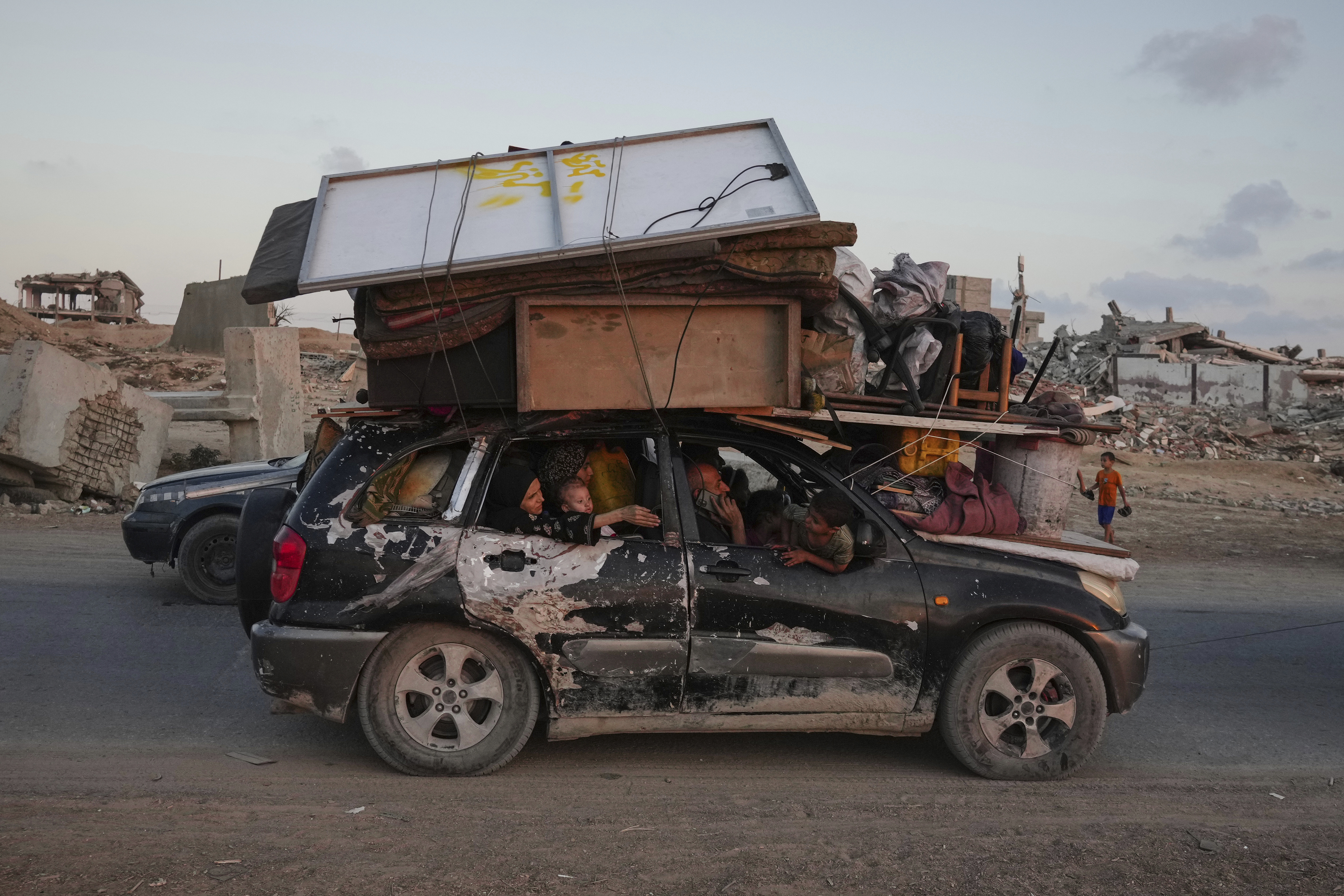 Displaced Palestinians fleeing northern Gaza carry their belongings along the coastal road toward southern Gaza ,Sunday, Sept. 7, 2025. (Jehad Alshrafi - AP)