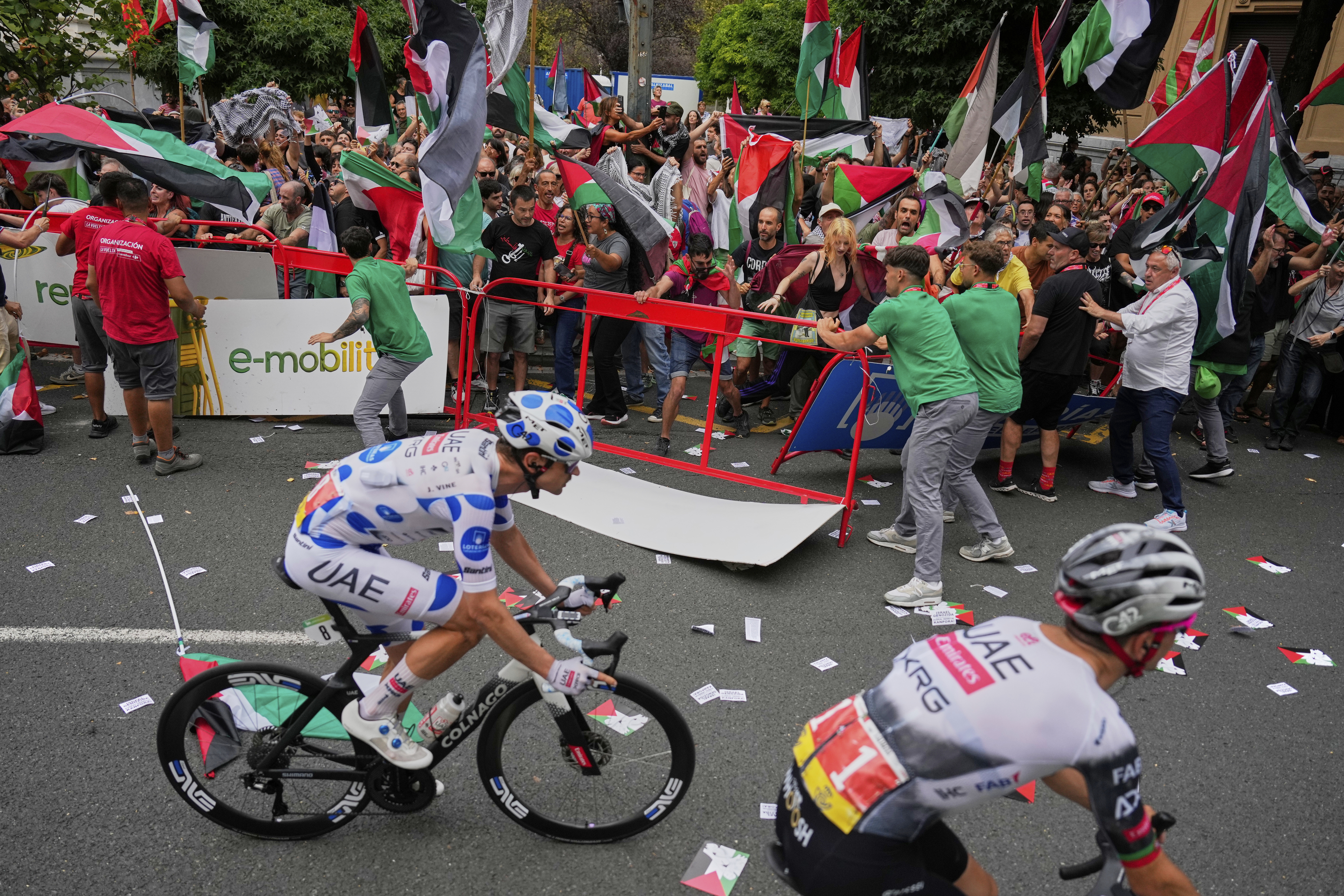 People hold Palestinian flags as they try to disrupt the eleventh stage of the Spanish Vuelta cycling race, from Bilbao to Bilbao, Spain, Wednesday, Sept. 3, 2025. (Miguel Oses - AP)