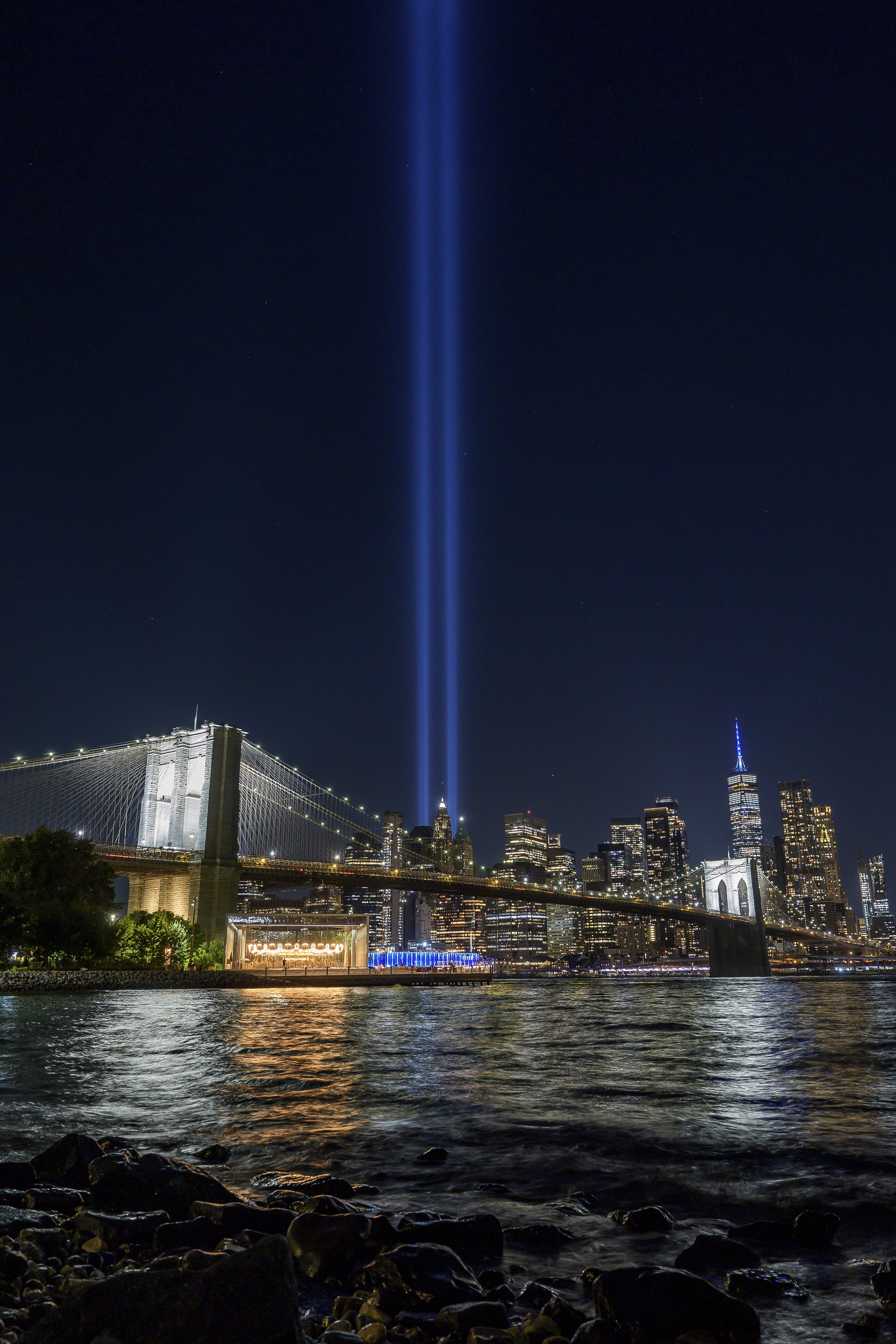 The annual Tribute in Light shines in the sky behind the Brooklyn Bridge, Thursday, Sept. 11, 2025, in the Brooklyn borough of New York. (Adam Gray - FR172090 AP)